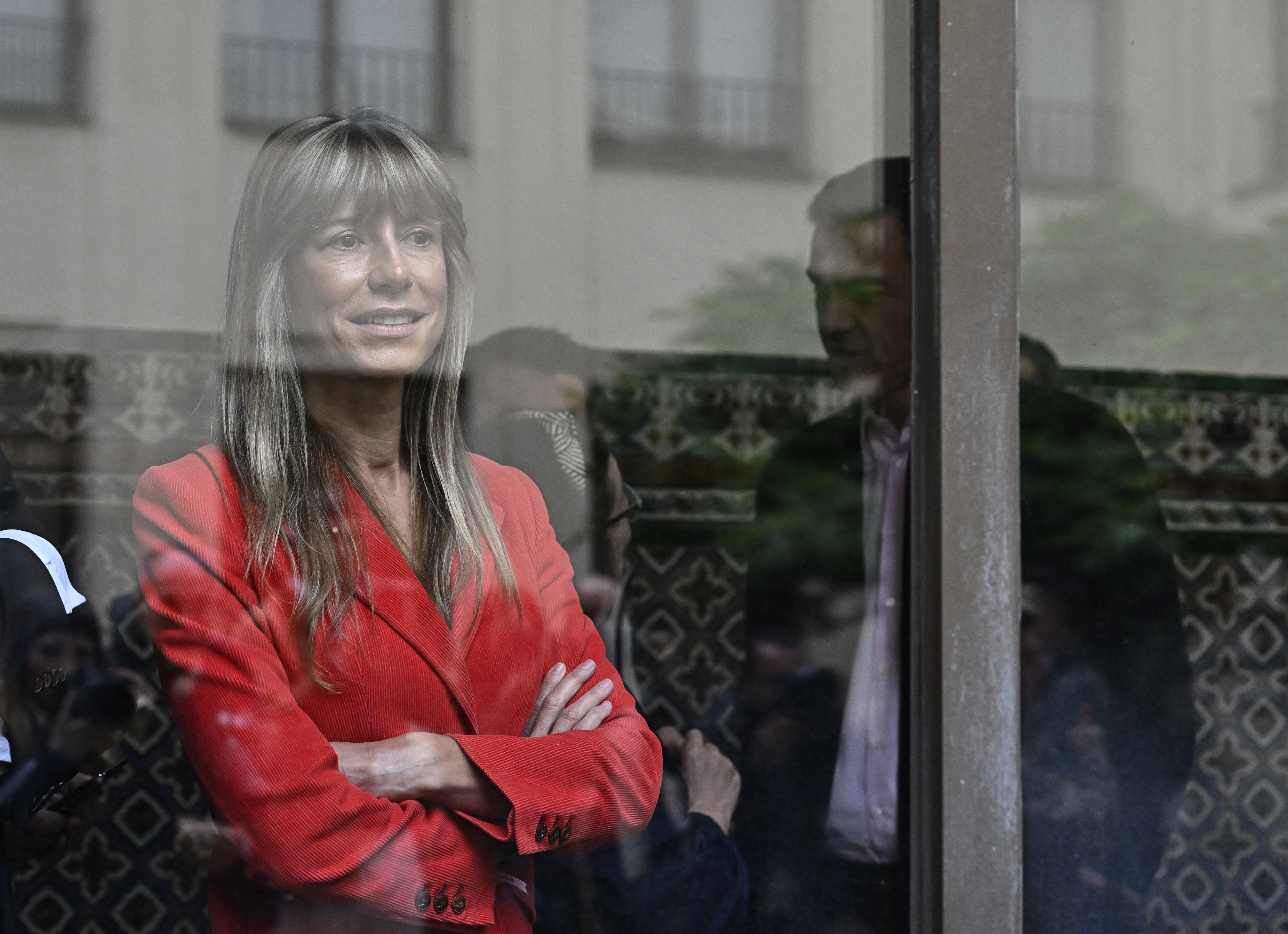 (FILES) Begona Gomez wife of Spain's Prime minister Pedro Sanchez (R) of Socialist Party (PSOE) is seen behind a window after casting her ballot in Madrid on May 28, 2023 during local and regional polls.