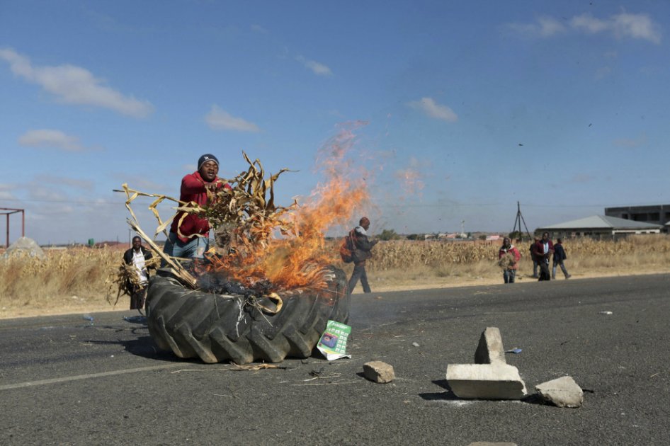 Un manifestante incendia un neumático en la carretera de Mutare, en las afueras de Harare. / EFE