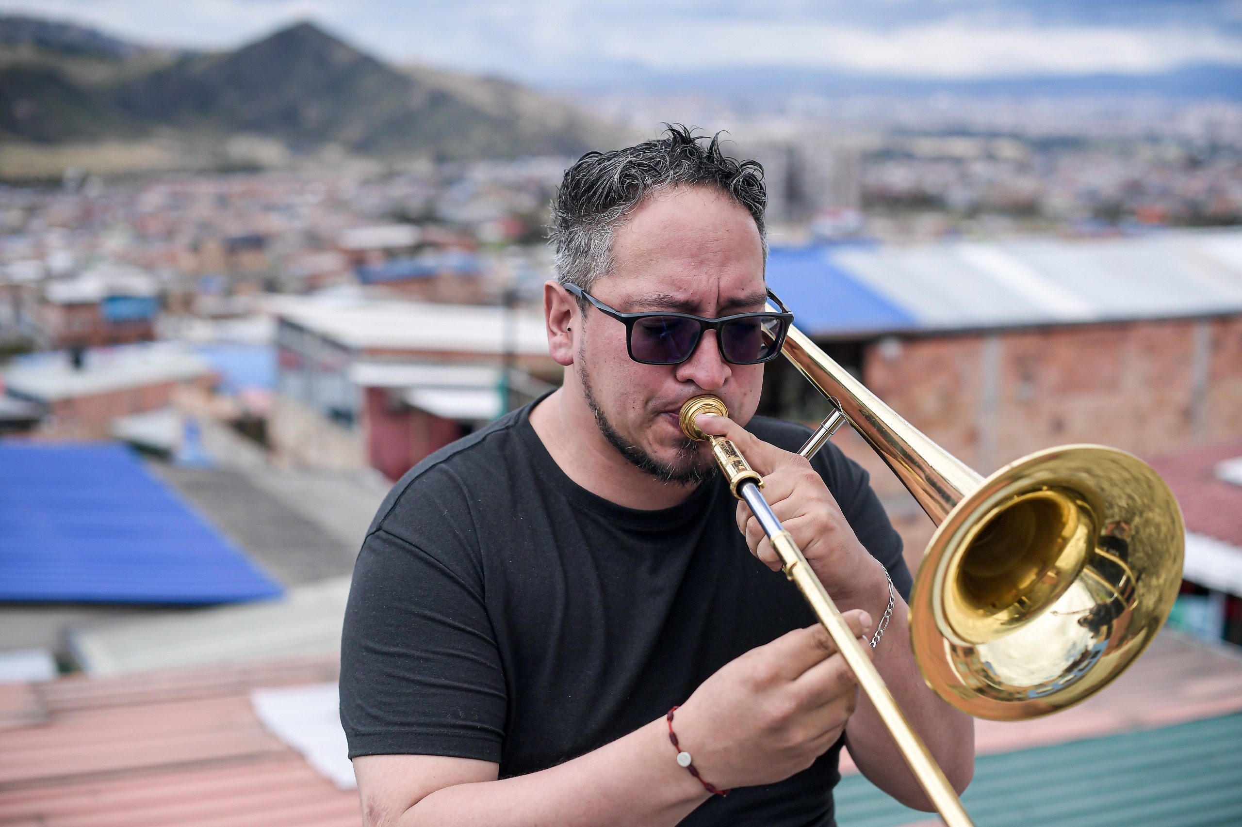 Cristian Camargo tocando trombón en Usme, barrio en donde creció y se formó como músico.
