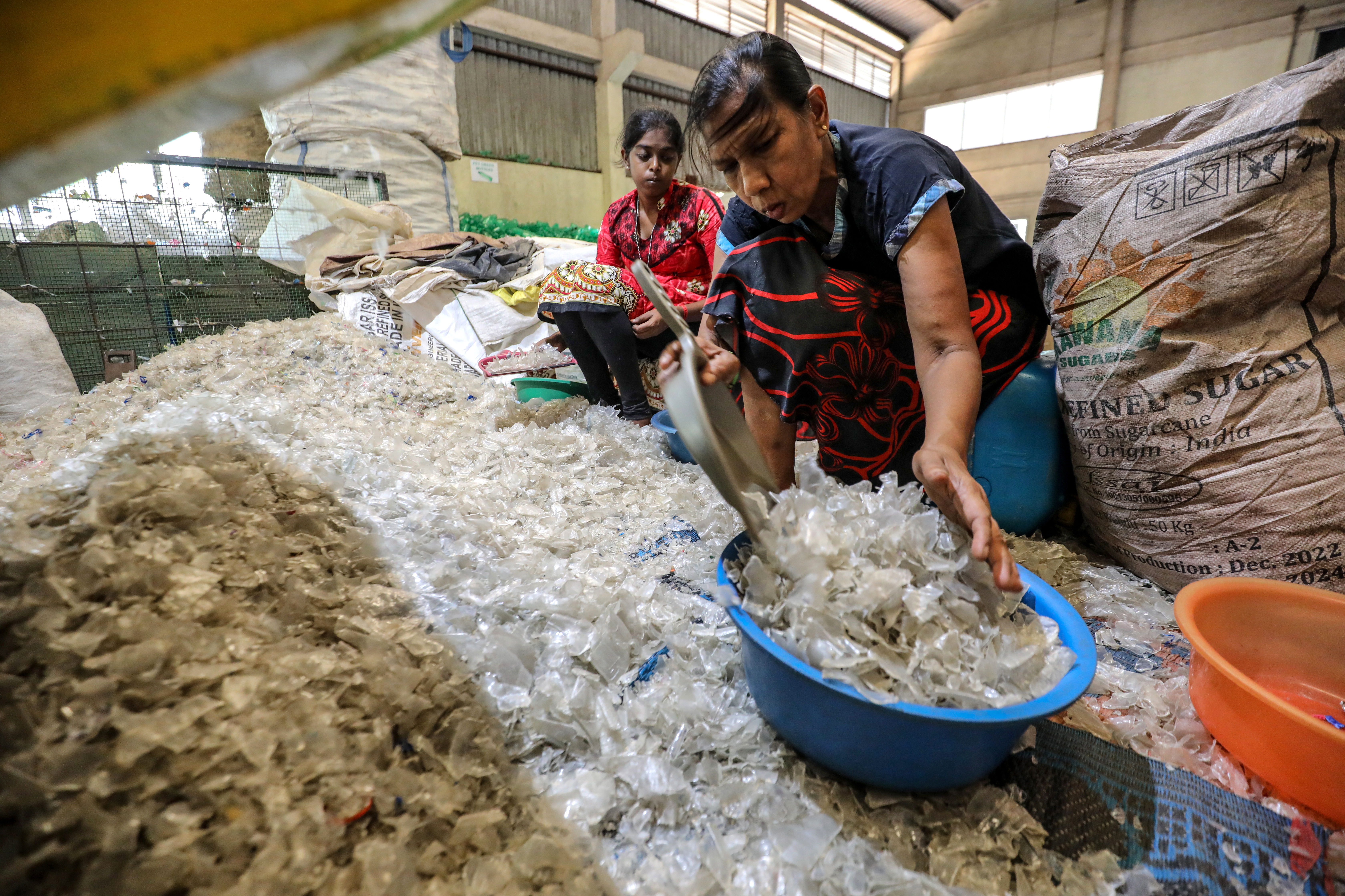 Colombo (Sri Lanka), 20/05/2023.- Female laborers gather plastic pieces at the Viridis Recycling Centre in Panagoda suburb of Colombo, Sri Lanka, 20 May 2023. (Issued 02 June 2023) According to the Sri Lanka Environment Ministry's "National Action Plan on Plastic Waste Management 2021-2030," an estimated 682 metric tons of plastic waste are generated in Sri Lanka each day. Meanwhile, only 11 percent of the total amount of plastic waste generated is recycled in a systematic manner. The world marks the World Environment Day on 5 June 2023 and it will focus on plastic Pollution and solutions to plastic Pollution. (Ciclismo) EFE/EPA/CHAMILA KARUNARATHNE ATTENTION: This Image is part of a PHOTO SET