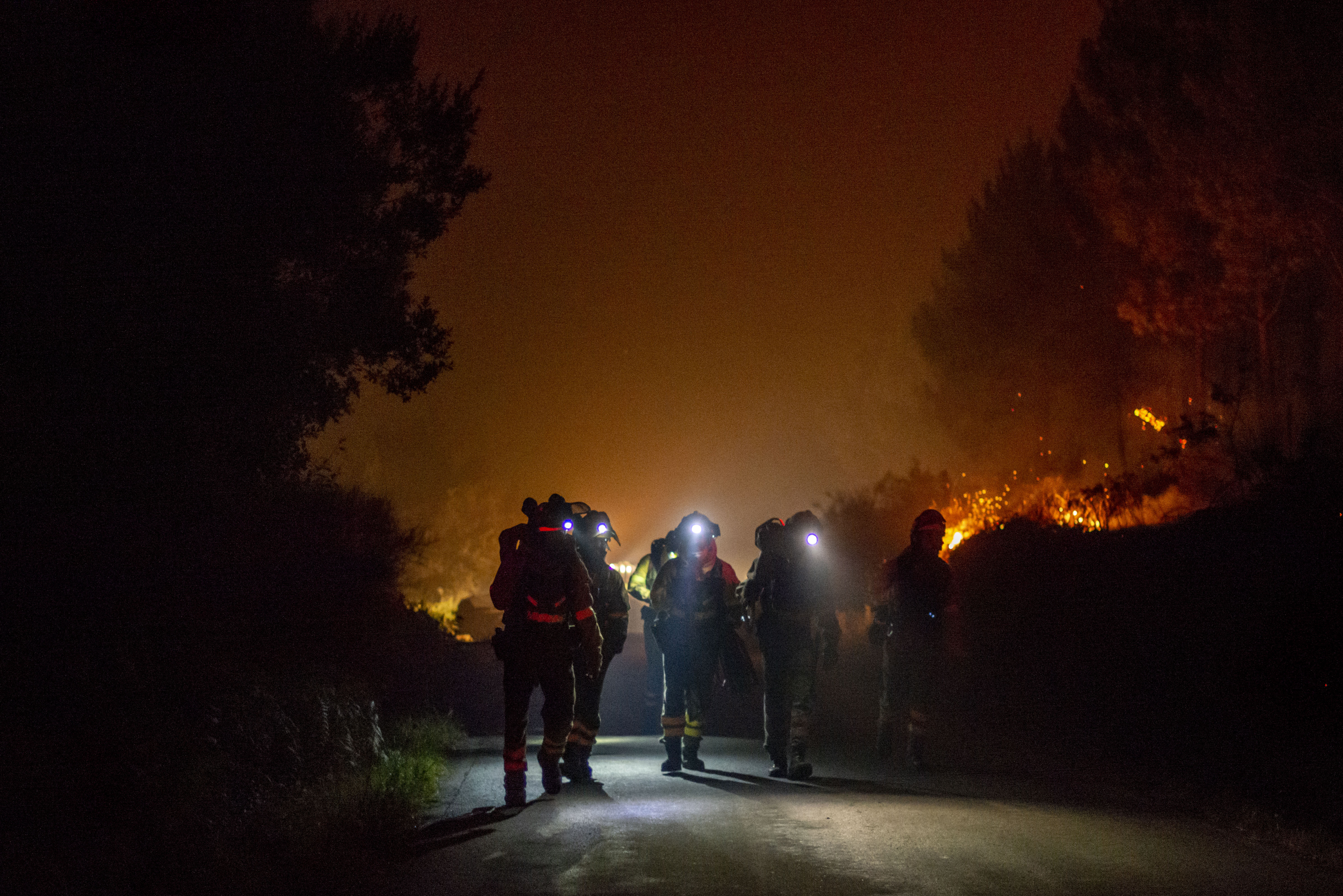 BOIRO (A CORUÑA), 06/08/2022.- Varios bomberos forestales trabajan en la extinción del incendio de Cures, en Boiro, A Coruña, en la madrugada de este sábado. EFE/Brais Lorenzo
