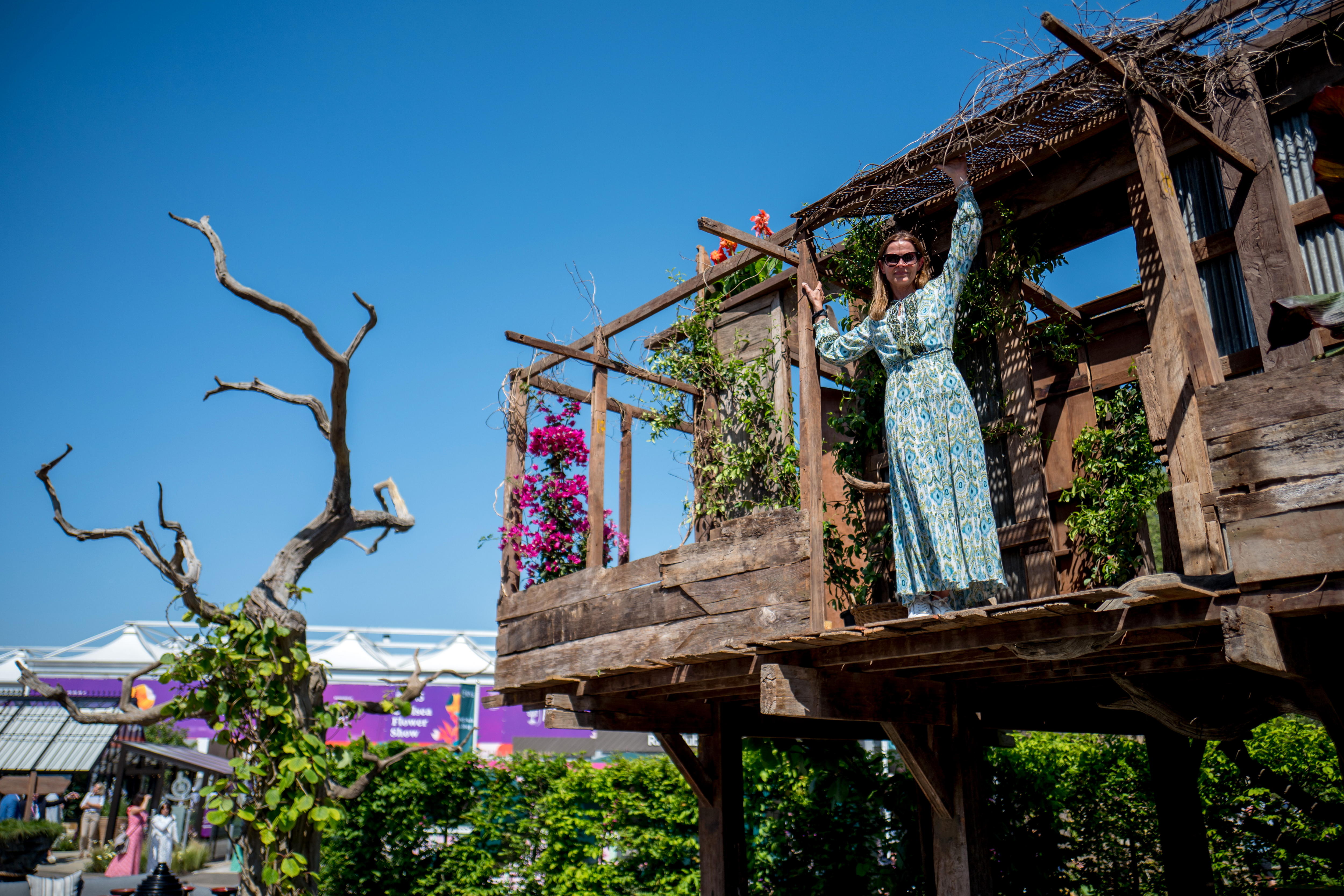 London (United Kingdom), 20/05/2024.- A person poses from a tree house display during the press day at the Chelsea Flower Show in London, Britain, 20 May 2024. The annual gardening exhibition runs from 21 to 25 May 2024 at the Royal Chelsea Hospital in London. (Reino Unido, Londres) EFE/EPA/TOLGA AKMEN