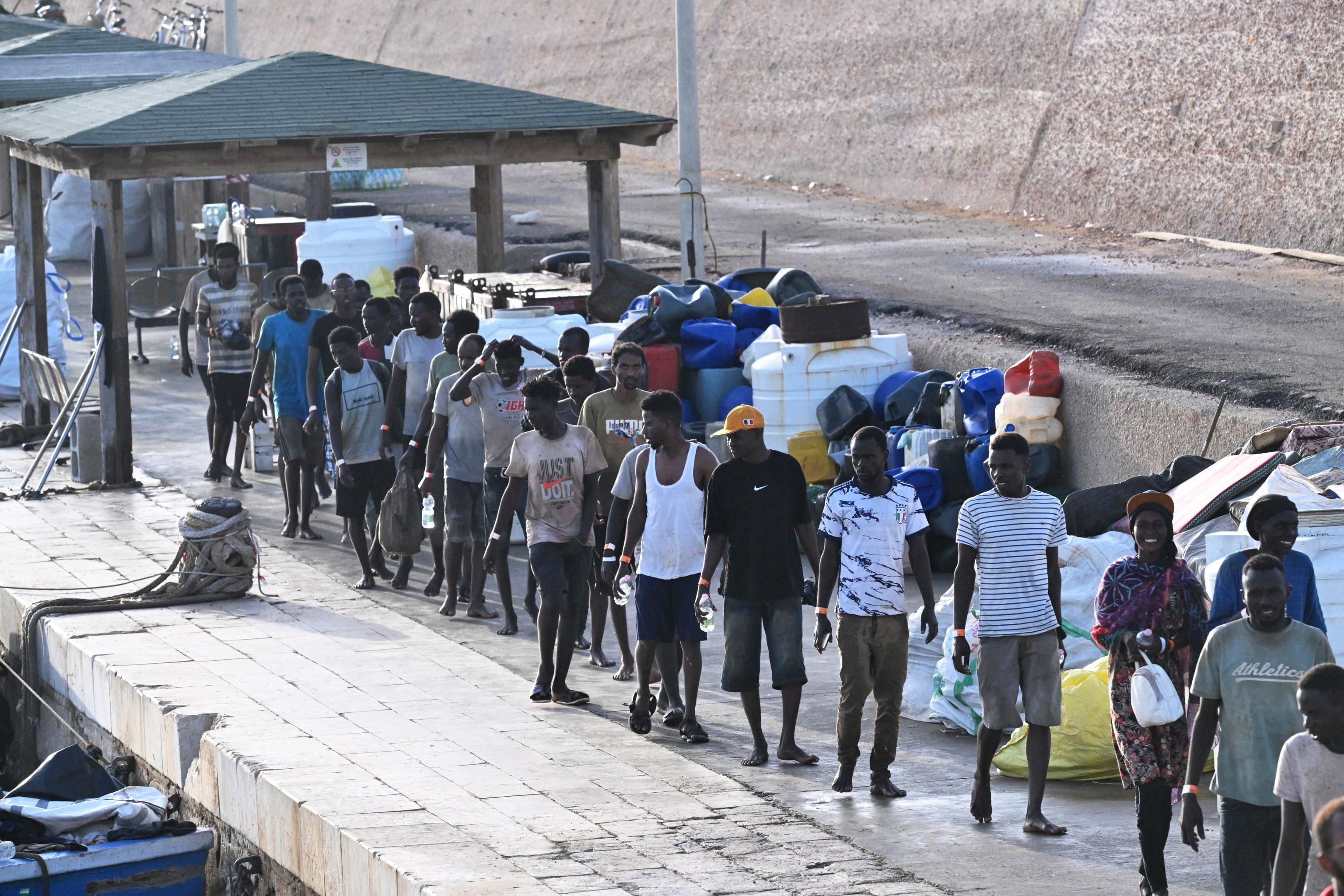 Lampedusa (Italy), 18/09/2023.- Migrants arrive at 'Molo Favarolo' in Lampedusa, southern Italy, 18 September 2023. Migrants traveling on a small boat were rescued by the Coast Guard. The group, after the health triage, will be transferred to the hotspot where, at the moment, there are 1,104 people. Italian Deputy Premier and Foreign Minister Antonio Tajani on 15 September called for the intervention of the United Nations in response to the significant increase in the arrival of migrants and refugees by sea to Italy in recent days. (Italia) EFE/EPA/CIRO FUSCO