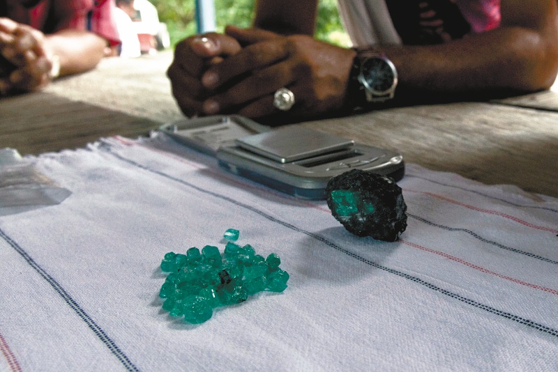 Emerald traders check the quality of freshly mined stones in Muzo, Colombia, on Friday, Sept. 16 2011. Colombia is the producer of the world's largest emeralds, the majority of which are mined in the mountains of the country's central region. Photographer: Alejandra Parra/Bloomberg