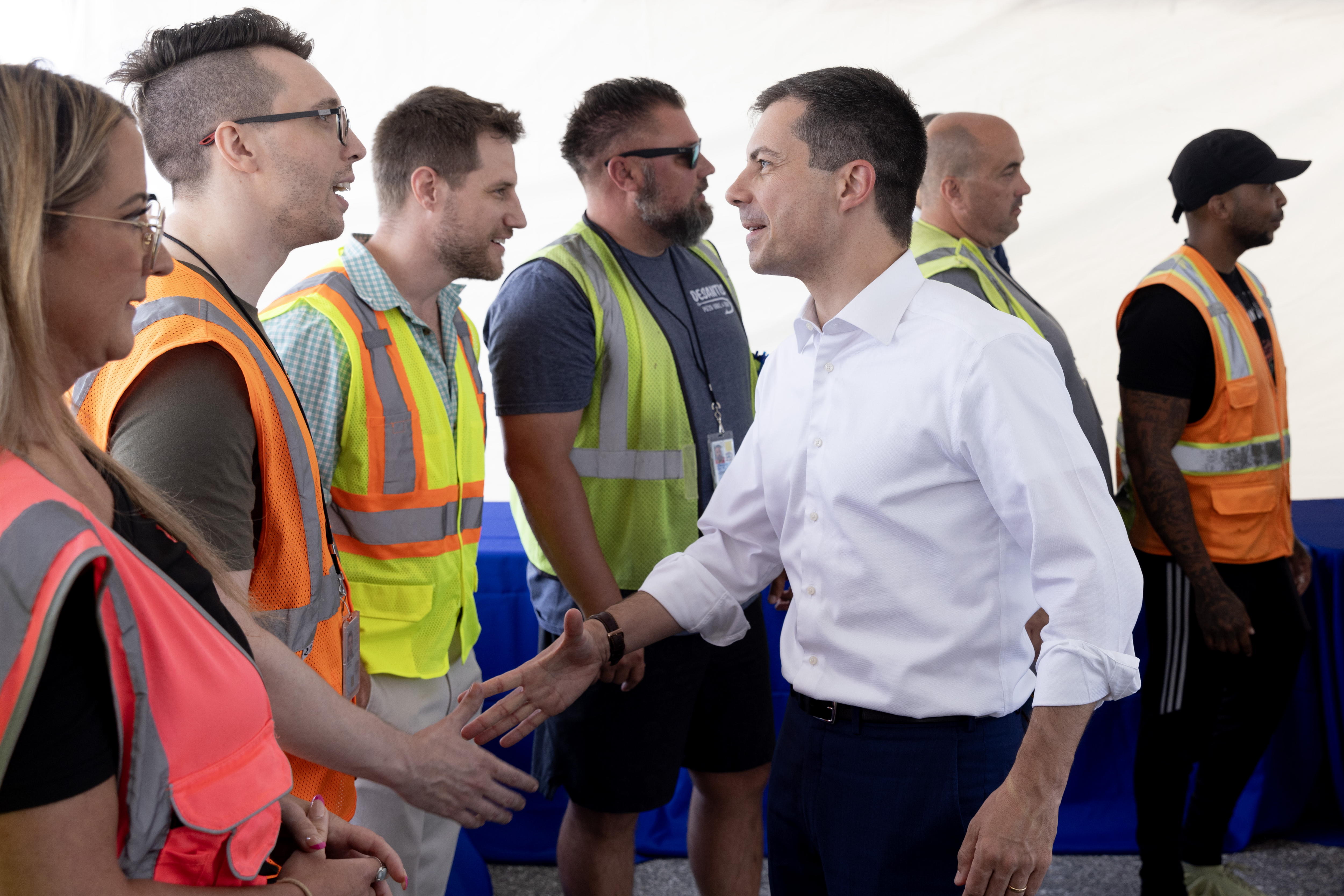 Baltimore (United States), 12/06/2024.- US Secretary of Transportation Pete Buttigieg (C) greets port workers before a news conference on the reopening of the Port of Baltimore, in Baltimore, Maryland, USA, 12 June 2024. The Port of Baltimore has fully reopened following the cleanup of the collapsed Francis Scott Key Bridge, which was destroyed when the cargo vessel Dali collided with it on 26 March, forcing the closure of the port. The Department of Transportation has estimated costs between 1.7 billion and 1.9 billion US Dollars to rebuild the destroyed bridge. EFE/EPA/MICHAEL REYNOLDS