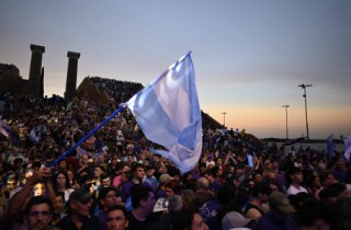 Supporters of Argentina's President Javier Milei wave an Argentine flag during the closing campaign rally of Libertad Avanza party ahead of the upcoming legislative elections in Rosario, Santa Fe province, Argentina on October 23, 2025.
