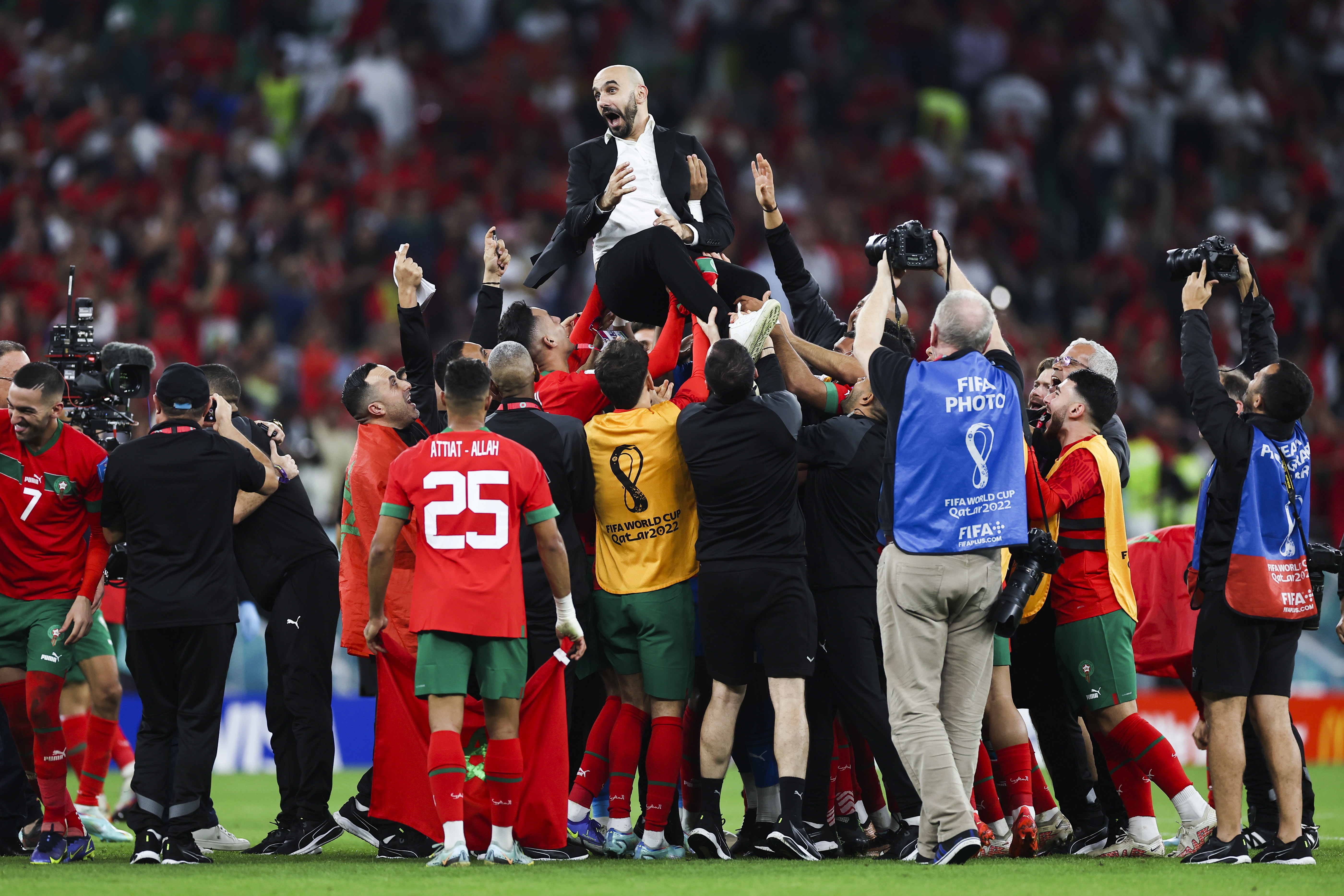 Doha (Qatar), 10/12/2022.- Morocco head coach Walid Regragui (top) and his players celebrate after the FIFA World Cup 2022 quarter final soccer match between Morocco and Portugal at Al Thumama Stadium in Doha, Qatar, 10 December 2022. (Mundial de Fútbol, Marruecos, Catar) EFE/EPA/JOSE SENA GOULAO