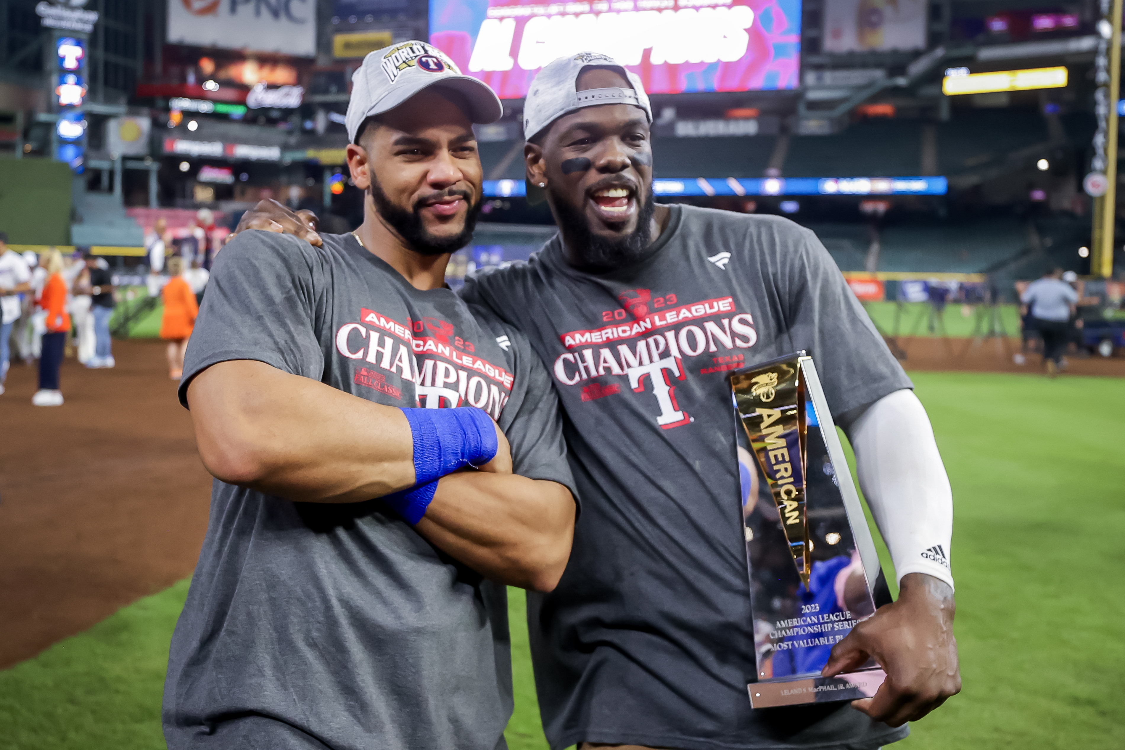 Houston (United States), 23/10/2023.- Texas Rangers right fielder Adolis Garcia (R) holds the Most Valuable Player trophy along side Rangers center fielder Leody Taveras (L) after the Texas Rangers defeated the Houston Astros during game seven of the Major League Baseball (MLB) American League Championship Series playoffs between the Texas Rangers and the Houston Astros at Minute Maid Park in Houston, Texas, USA, 23 October 2023. The best-of-seven series is tied at three games each. (Liga de Campeones) EFE/EPA/ADAM DAVIS