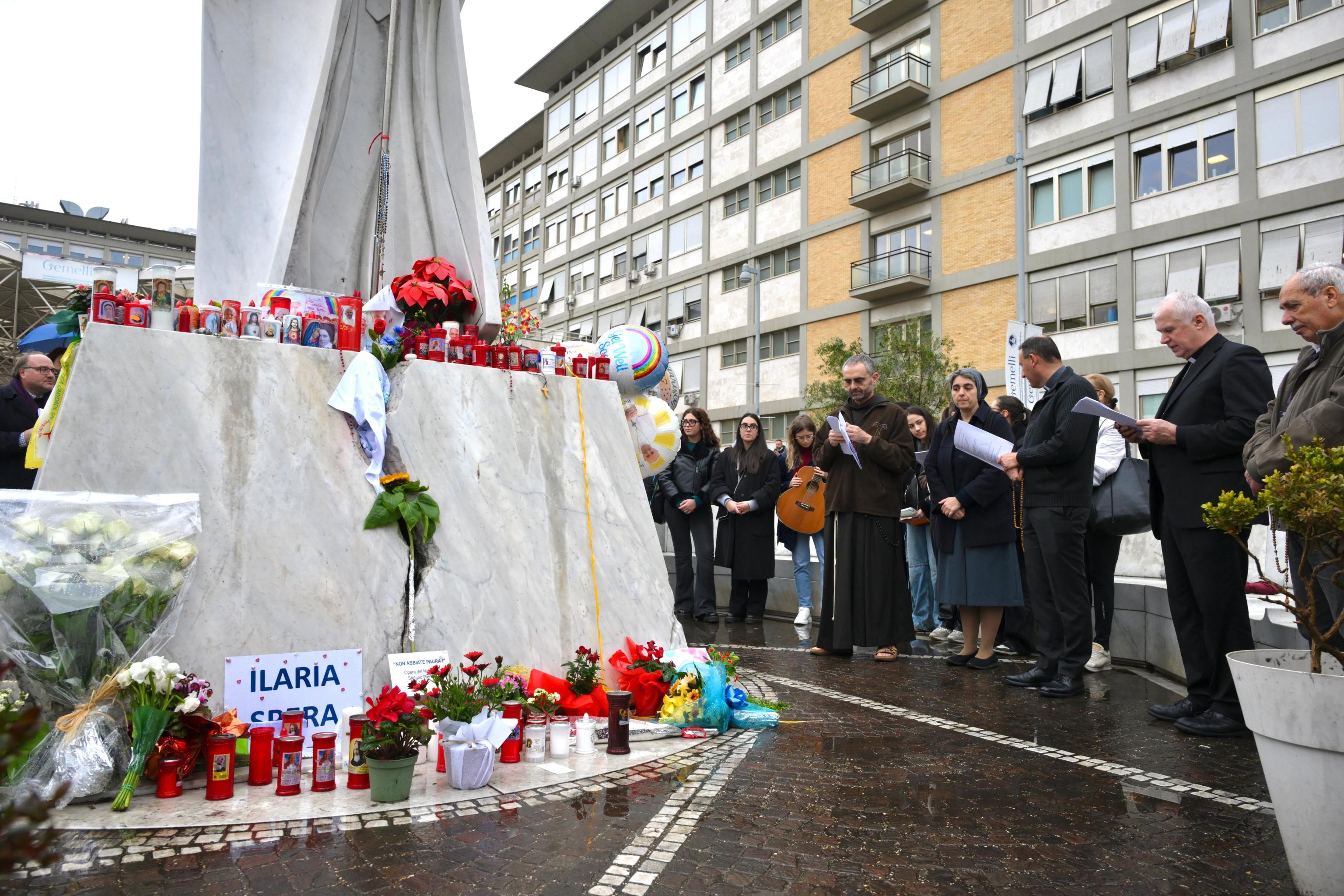 ROME (Italy), 24/02/2025.- Faithful pray before the statue of late Pope John Paul II outside the Agostino Gemelli Hospital where Pope Francis is hospitalized in Rome, Italy, 24 February 2025. The pope was admitted on 14 February due to a respiratory tract infection. (Papa, Italia, Roma) EFE/EPA/ALESSANDRO DI MEO