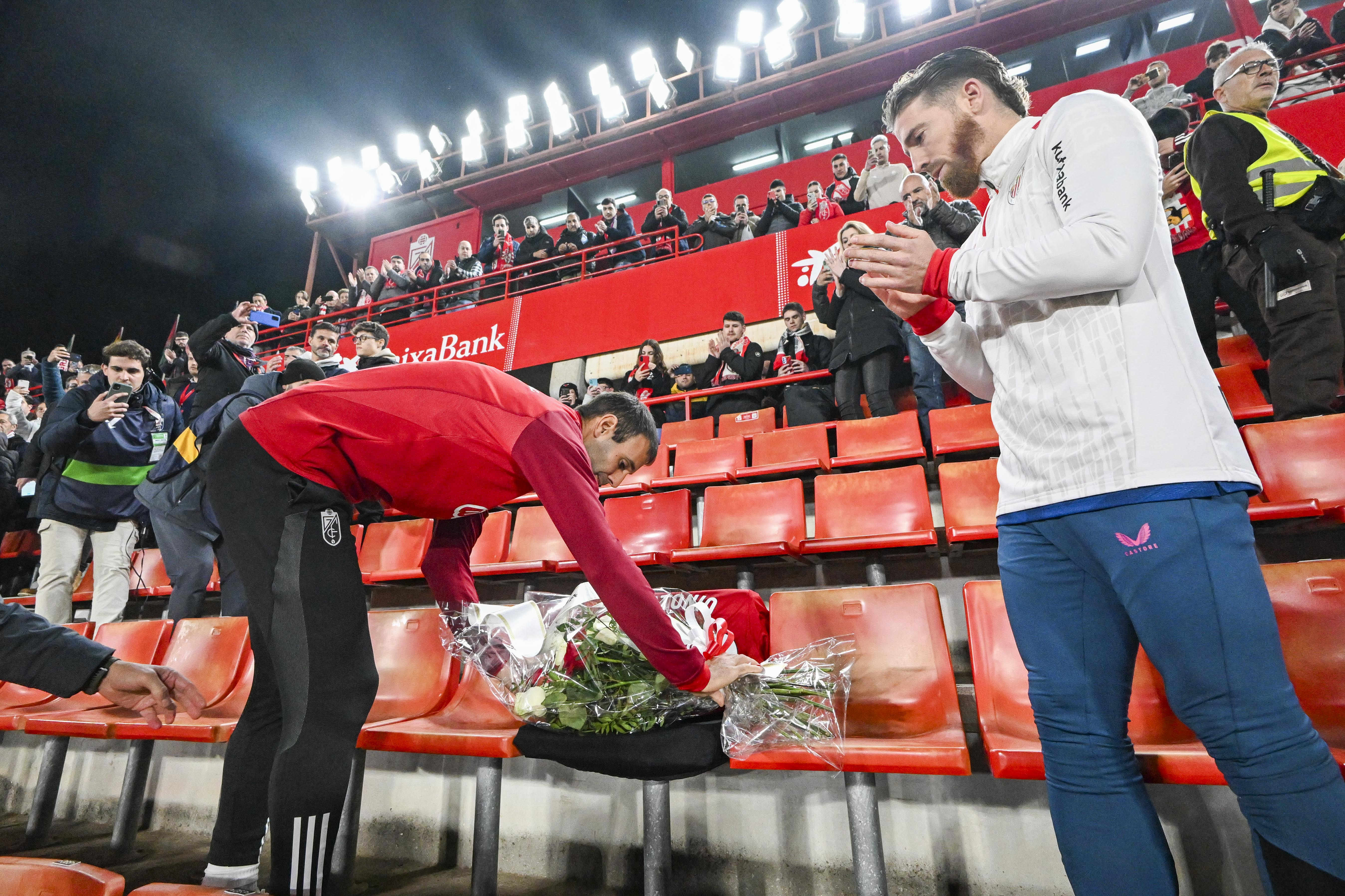 GRANADA, 11/12/23.- Los capitanes del Granada, Victor Díaz y del Atletic Club, Iker Muniain, durante el homenaje realizado al socio del Granada fallecido ayer en el encuentro correspondiente a la jornada 16 de Primera División que disputaban Granada y Athletic Club en el estadio Nuevo Los Cármenes y que se reiniciara hoy lunes tras ser suspendido por el fallecimiento del seguidor granadino. EFE / Miguel Ángel Molina.