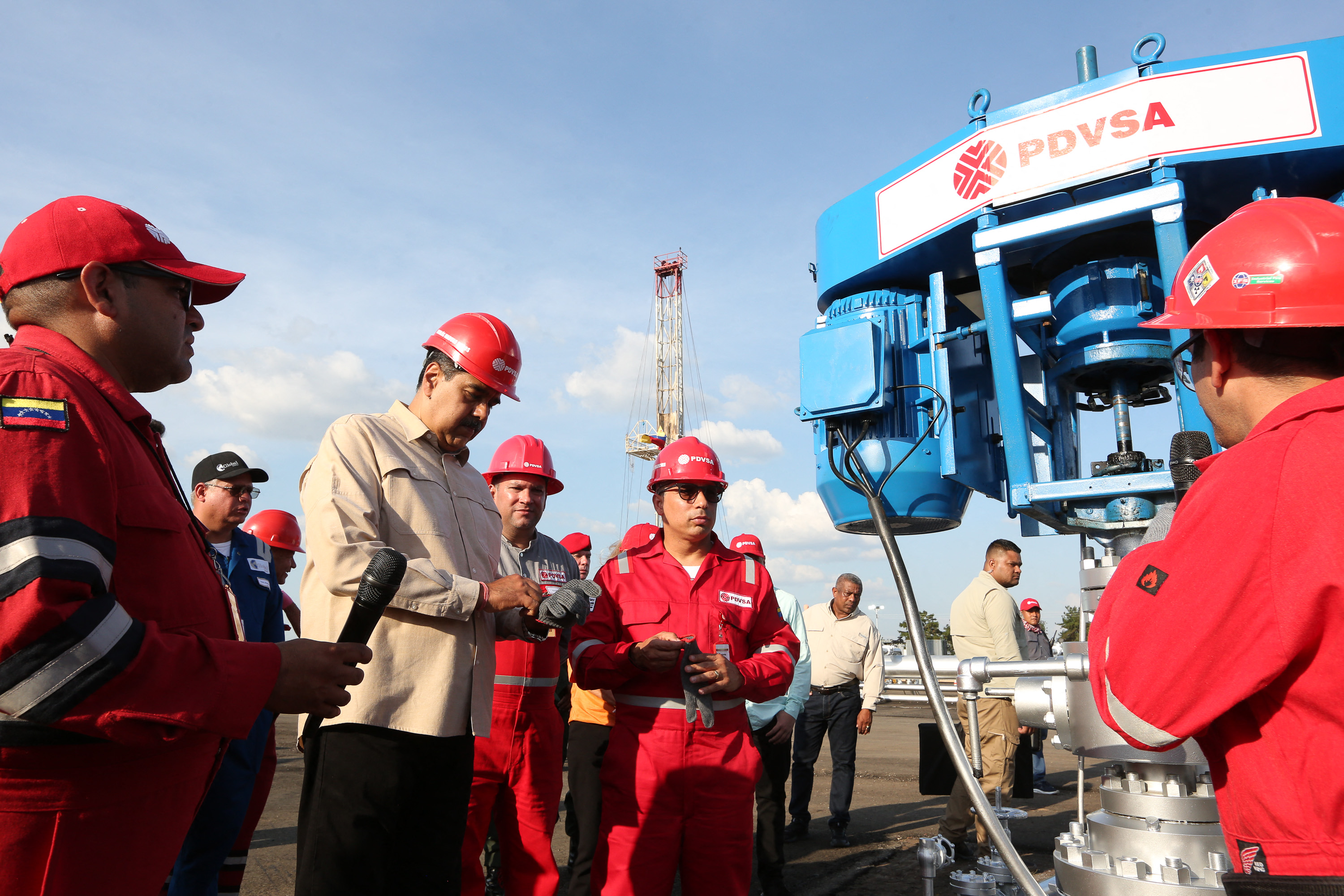 (FILES) Handout photo released by Miraflores presidential palace press office showing Venezuela's President Nicolas Maduro (C) taking part in the the delivery of 50 oil wells of the Cacique Chaima oil field to produce about 9,000 barrels per day for the estatal company PDVSA in Monagas state, Venezuela on May 3, 2023.