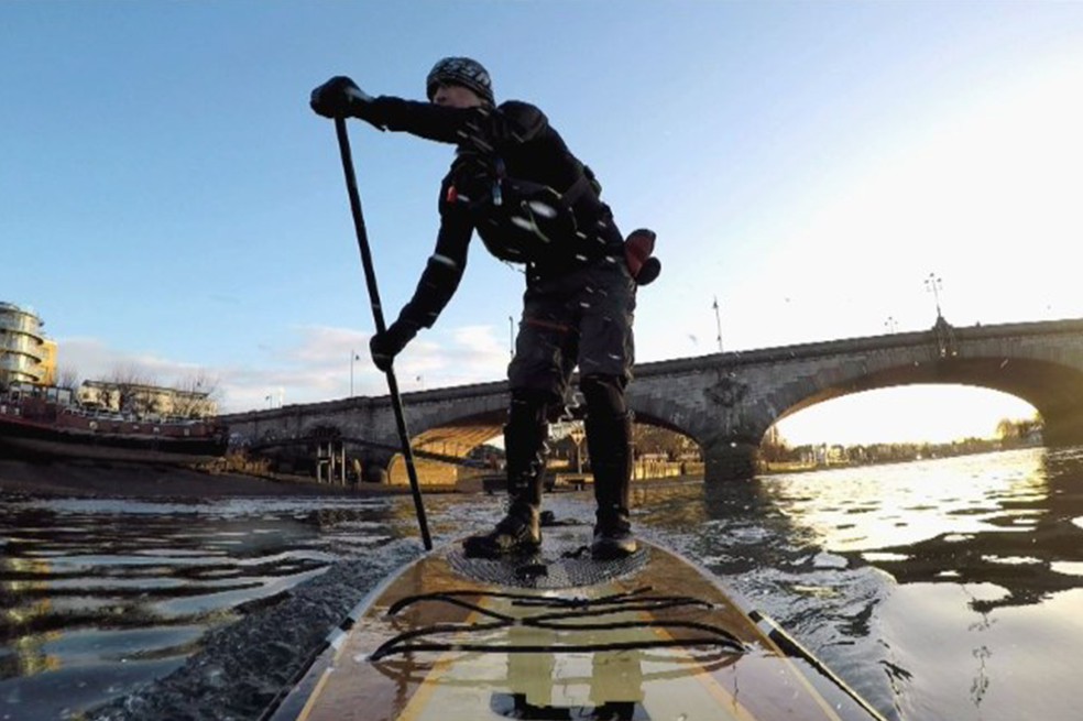 Activistas limpian el río Támesis sobre tablas de surf