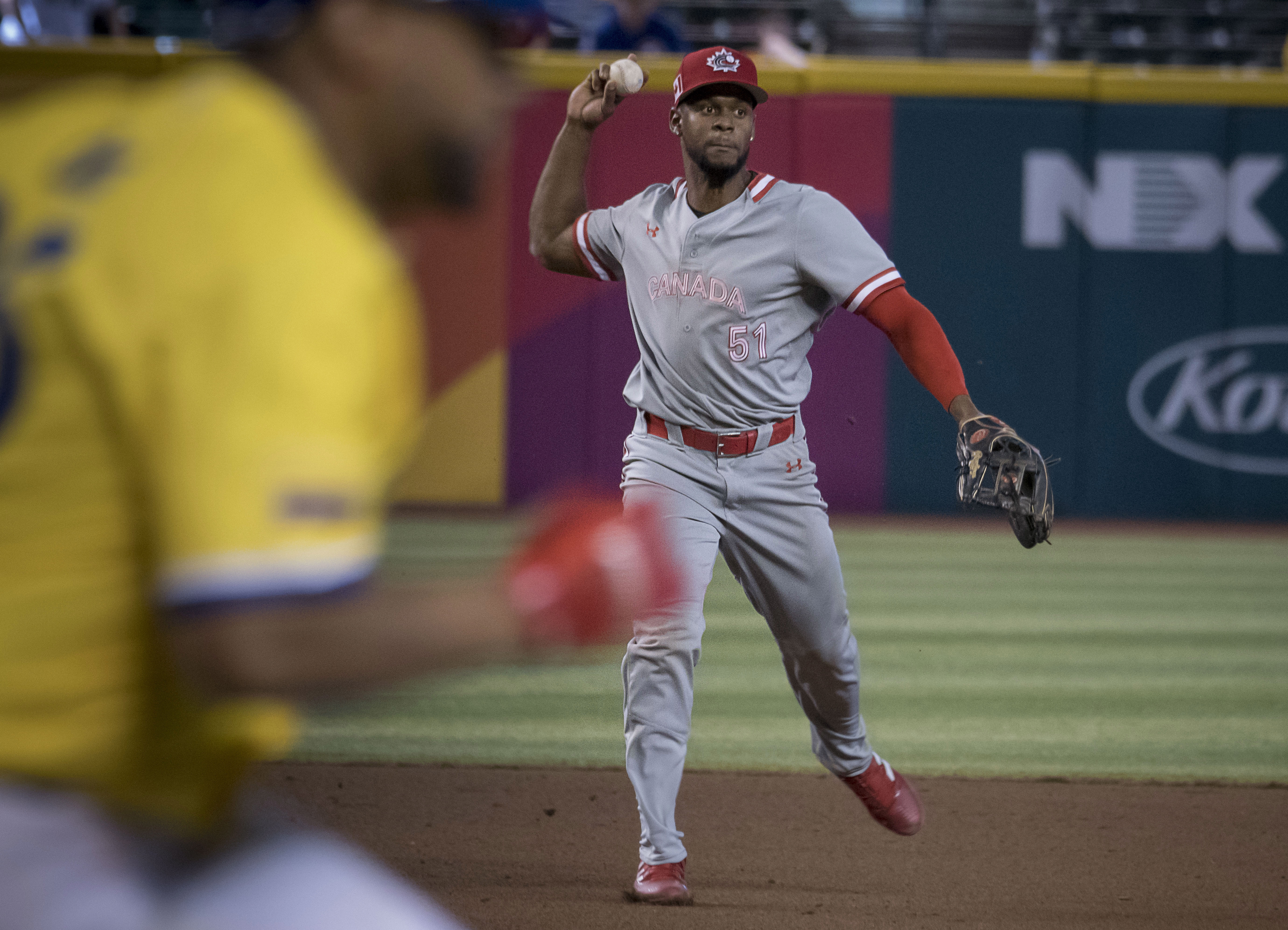 Phoenix (United States), 14/03/2023.- Otto Lopez (C) of Canada throws over to first base off a hit ball against Colombia during the World Basball Classic, Group C Tournament at Chase Field in Phoenix, Arizona, USA, 14, March 2023. (Estados Unidos, Fénix) EFE/EPA/Rick D'Elia