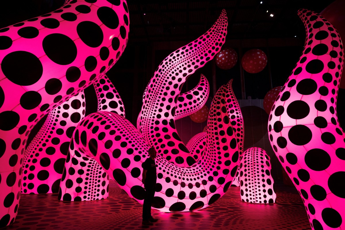 (FILES) A man admires an artwork entitled 'A Bouquet of Love I Saw in the Universe' which features in an exhibition by Japanese artist Yayoi Kusama entitled 'You, Me and the Balloons' in the Aviva Studios gallery in Manchester, northwest England, on June 29, 2023.