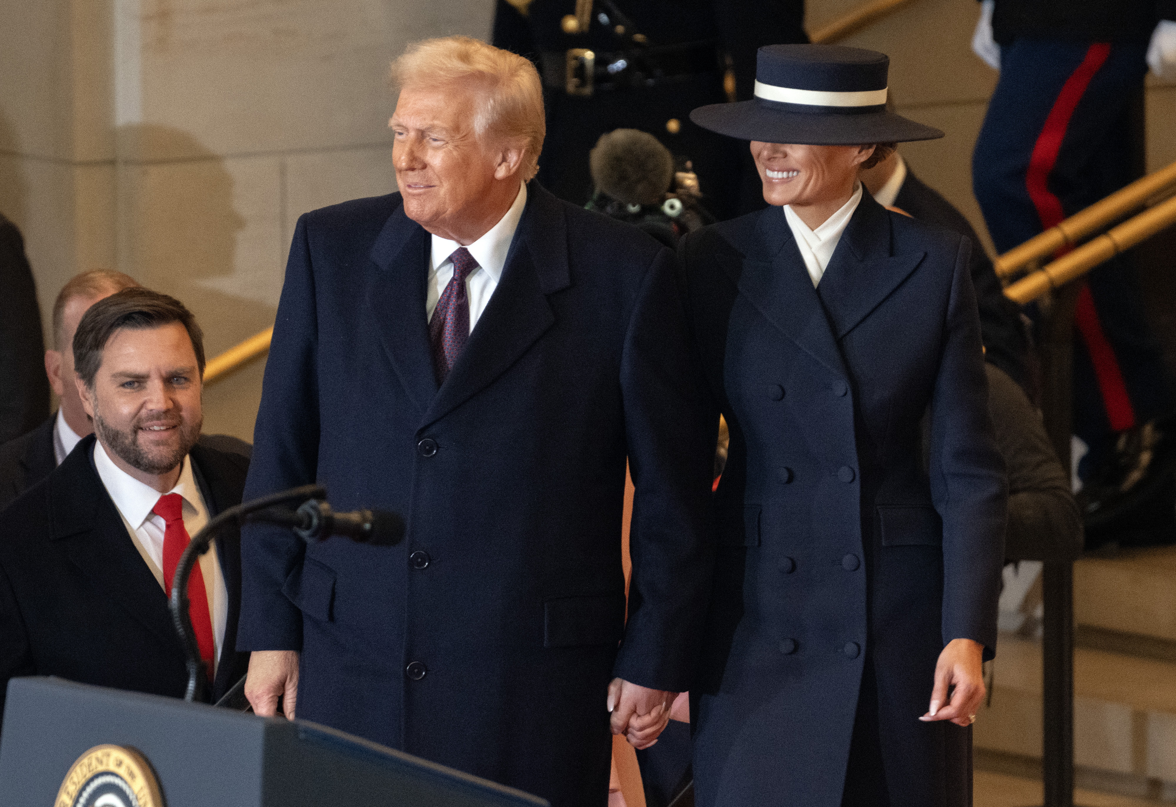 Washington (United States), 20/01/2025.- US President-elect President Donald J Trump (C) and former first lady Melania Trump (R) arrive in Emancipation Hall following his inaugural address in Washington, DC., USA, 20 January 2025. US President-elect Donald Trump will be sworn in for a second term as president of the United States on 20 January. The presidential inauguration will be held indoors due to extreme cold temperatures in DC. (Estados Unidos) EFE/EPA/RON SACHS / POOL