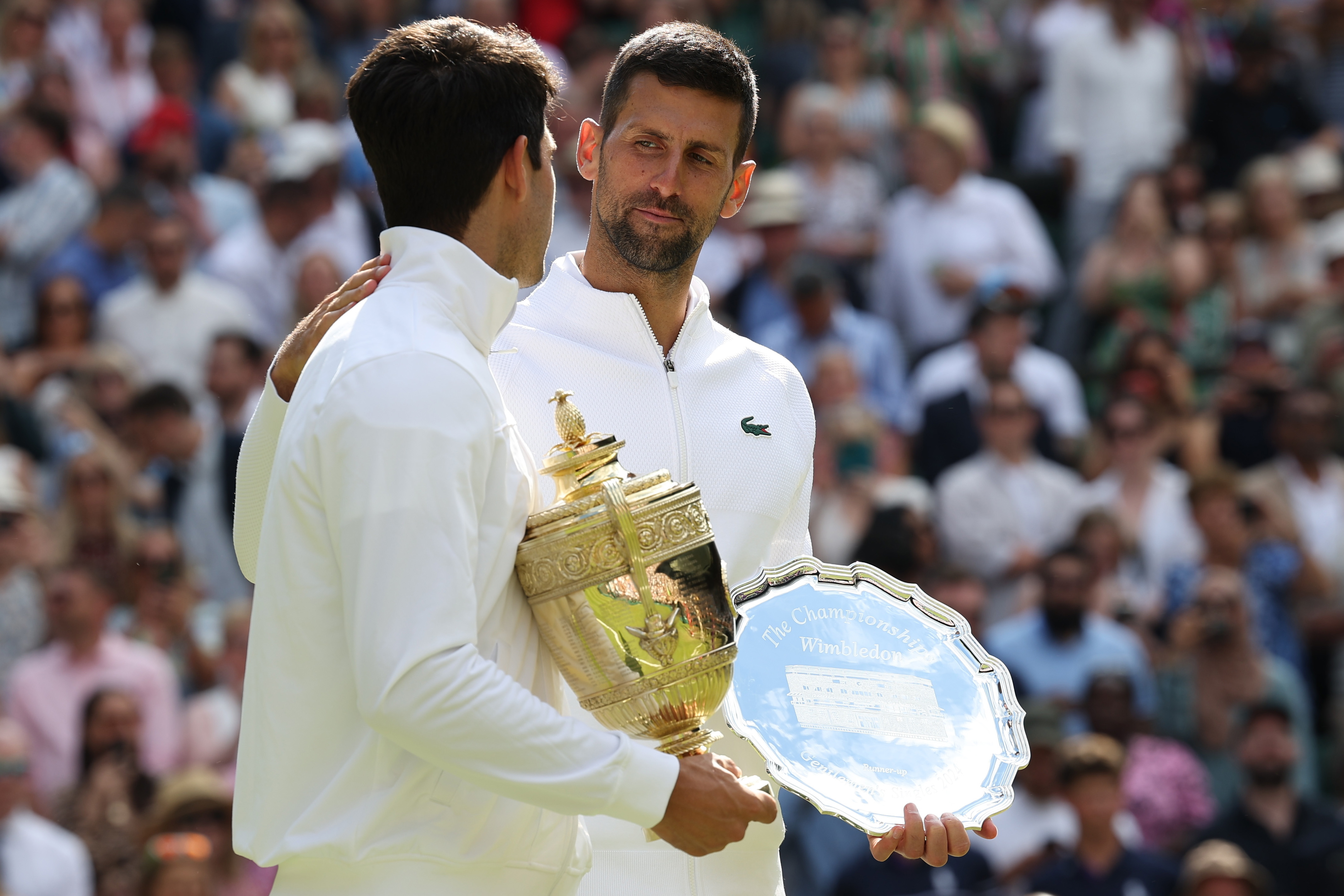 Wimbledon (United Kingdom), 14/07/2024.- Carlos Alcaraz of Spain (L) celebrates with his trophy after winning the Men's final against Novak Djokovic of Serbia (with his runner-up trophy) at the Wimbledon Championships, Wimbledon, Britain, 14 July 2024. (Tenis, España, Reino Unido) EFE/EPA/ADAM VAUGHAN EDITORIAL USE ONLY