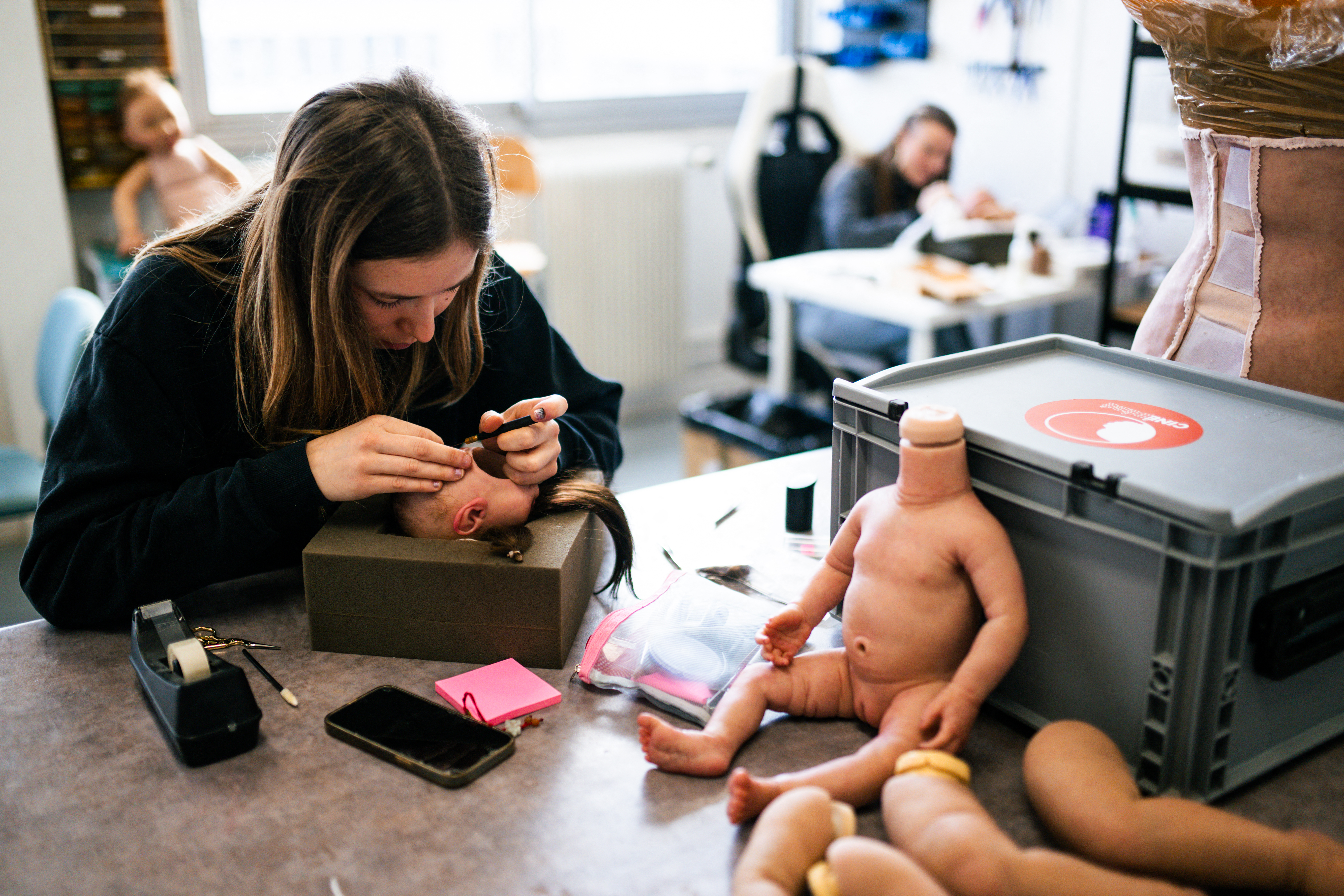 (FILES) An employee adds mohair to create the hairs on a fake baby head made for cinema and television created by Cinebebe (Cinebaby), a specialised brand of the Studio Junon -a company creating visual effects- in Saint-Denis, suburbs of Paris, on January 27, 2025.