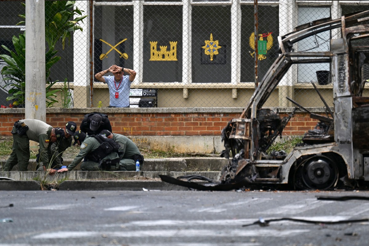 Colombian bomb disposal officers inspect a bus bomb after an explosion near a military base in Cali, Valle del Cauca department, Colombia taken on April 24, 2026.