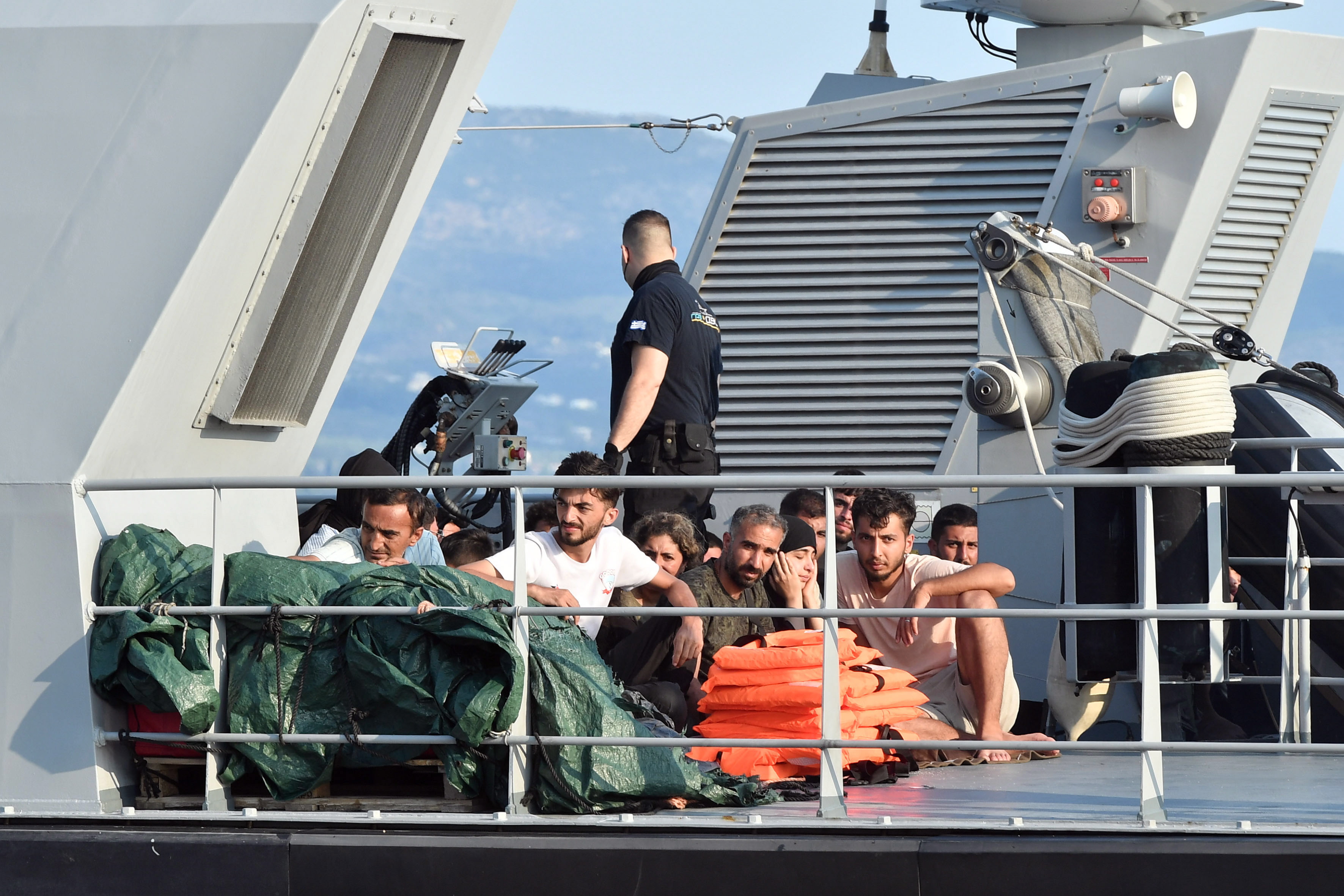 Kalamata (Greece), 21/06/2023.- Migrants onboard of a Coast Guard vessel arrive to port in Kalamata, Peloponnese, Greece, 21 June 2023. The vessel transported 63 migrants, who were found on a sailboat 27 nautical miles southwest of Tainaros, Greece. The rescued people, who say they are mainly citizens of Iraq, Iran, Syria and Morocco, have been transferred to the warehouses where they will remain until the migration proceedings are completed. (Grecia, Marruecos, Siria) EFE/EPA/NIKITAS KOTSIARIS