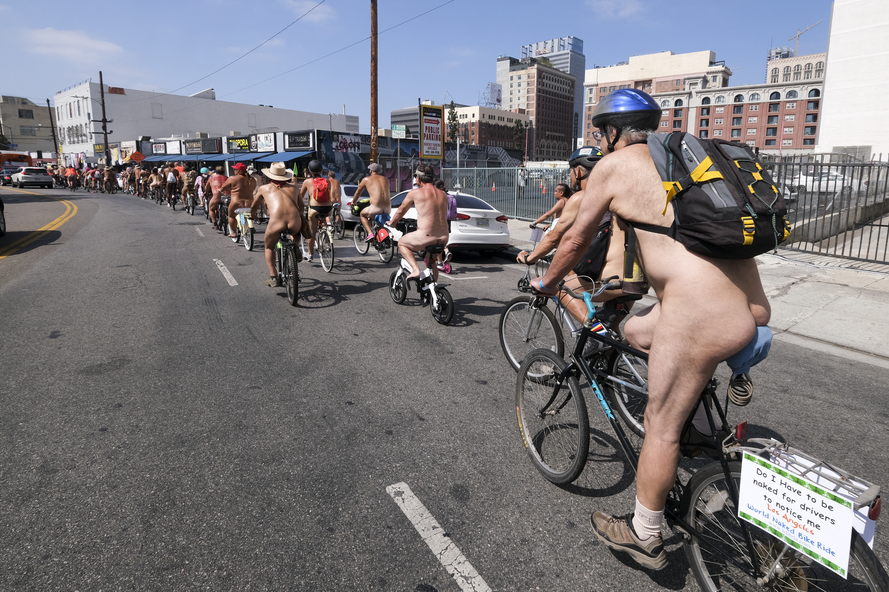 EDITORS NOTE: Graphic content / Nude cyclists get ready for the World Naked Bike Ride on September 18, 2021 in downtown Los Angeles. (Photo by RINGO CHIU / AFP)