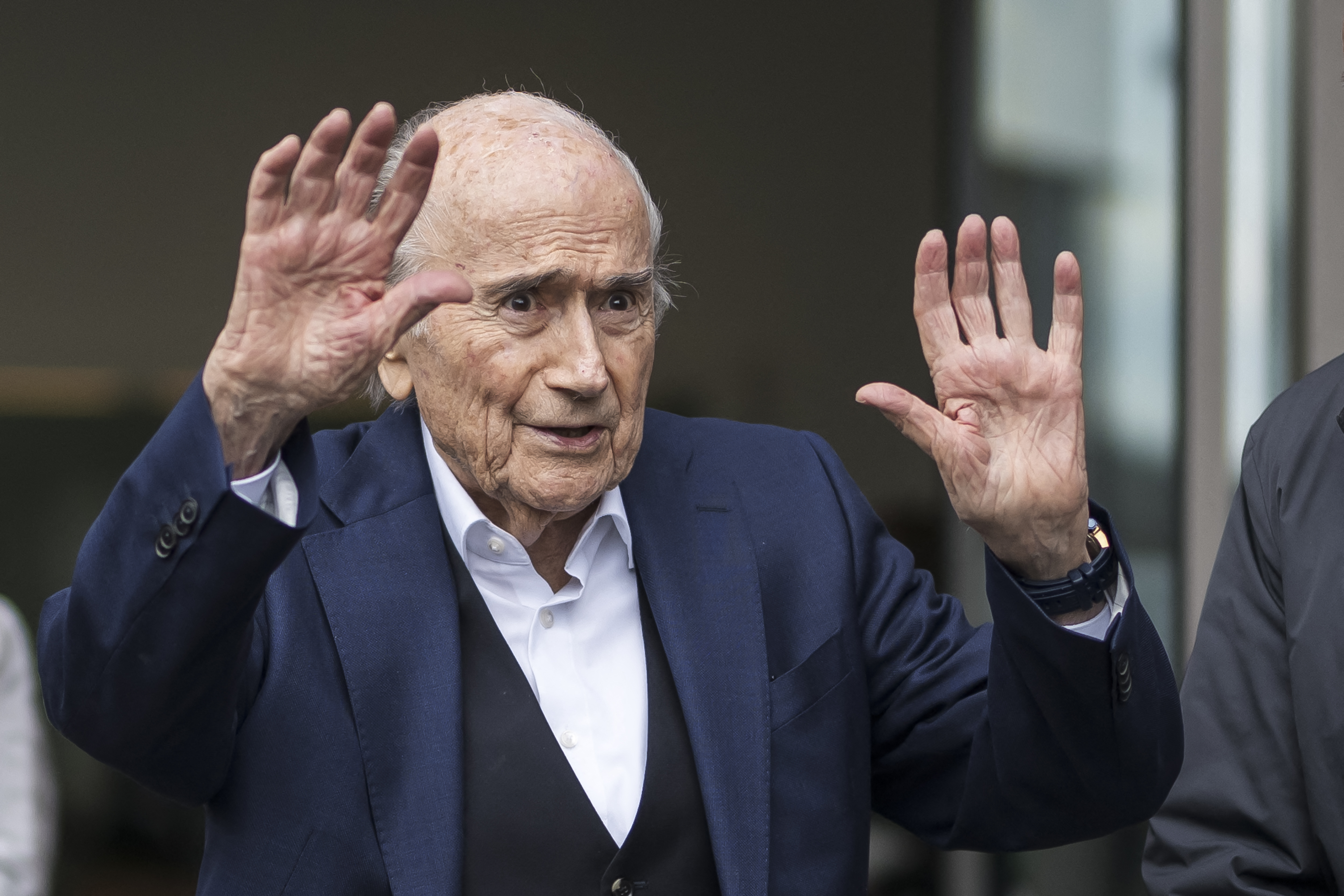 (FILES) Former FIFA president Sepp Blatter reacts as he leaves the courthouse after the verdict of an appeal by Swiss Attorney General's office against former UEFA and FIFA presidents over a suspected fraudulent payment, in Muttenz near Basel, on March 25, 2025.
