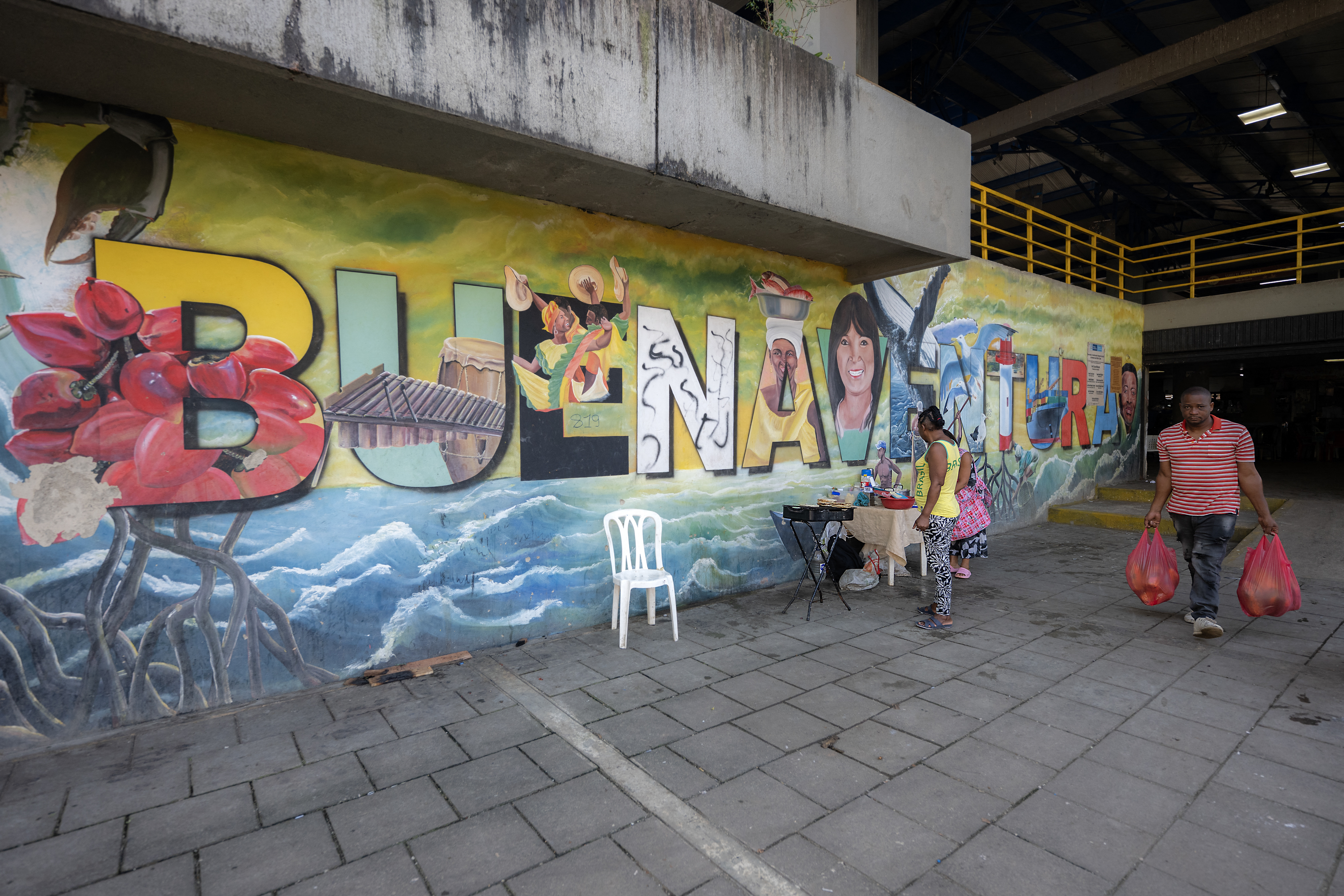 A man walks past a popular market in Buenaventura, Valle del Cauca department, Colombia, on September 4, 2024.