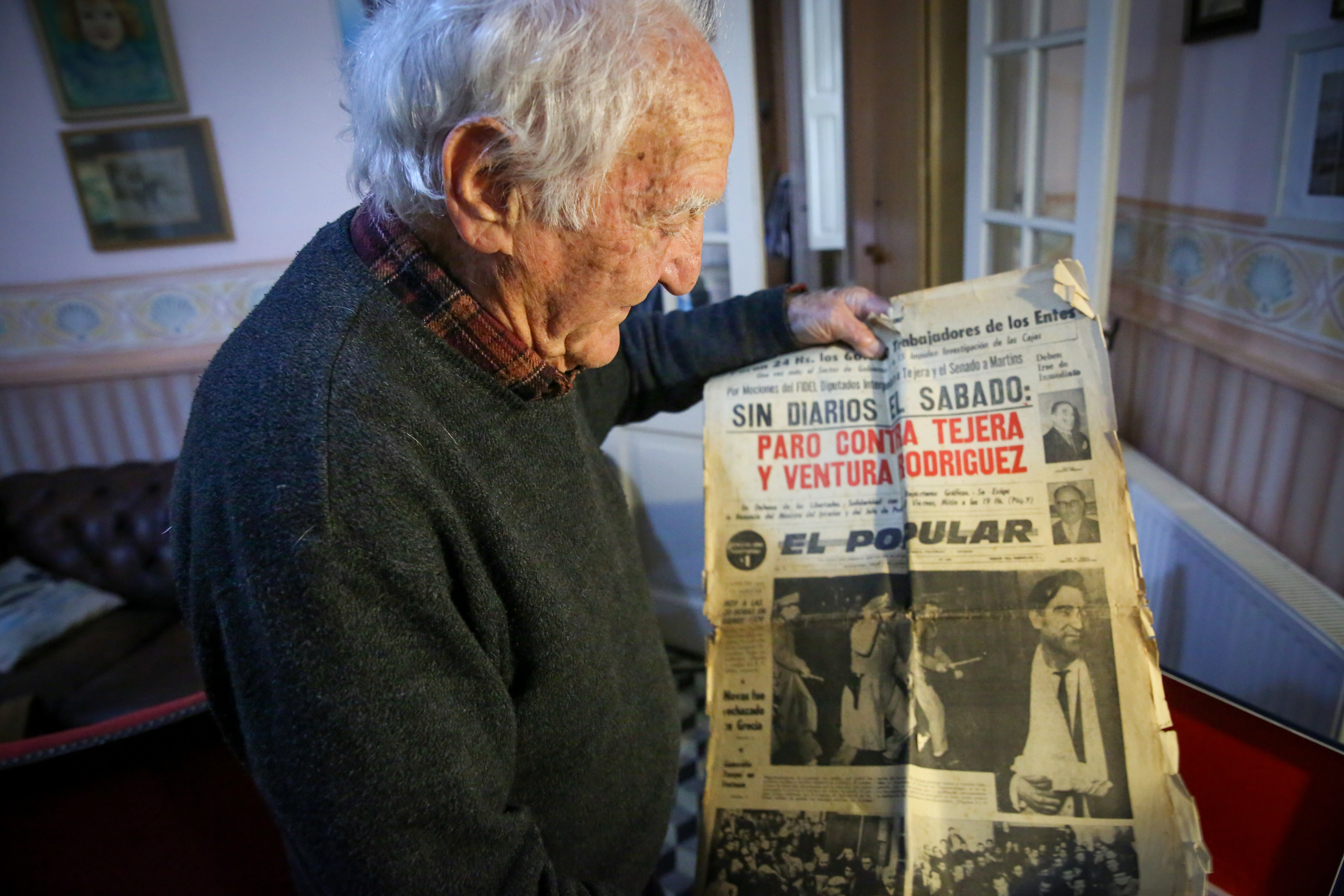 AME7064. MONTEVIDEO (URUGUAY), 04/08/2022.- El fotógrafo uruguayo Aurelio González muestra una portada de un periódico con su fotografía durante una entrevista con Efe, el 27 de julio de 2022, en Montevideo (Uruguay). Llegó como polizón desde Marruecos a Uruguay, retrató la dictadura de ese país en 1973 y se exilió en México: a sus 90 años, el fotógrafo Aurelio González es el rostro de una historia de resiliencia a través del lente. EFE/ Raúl Martínez
