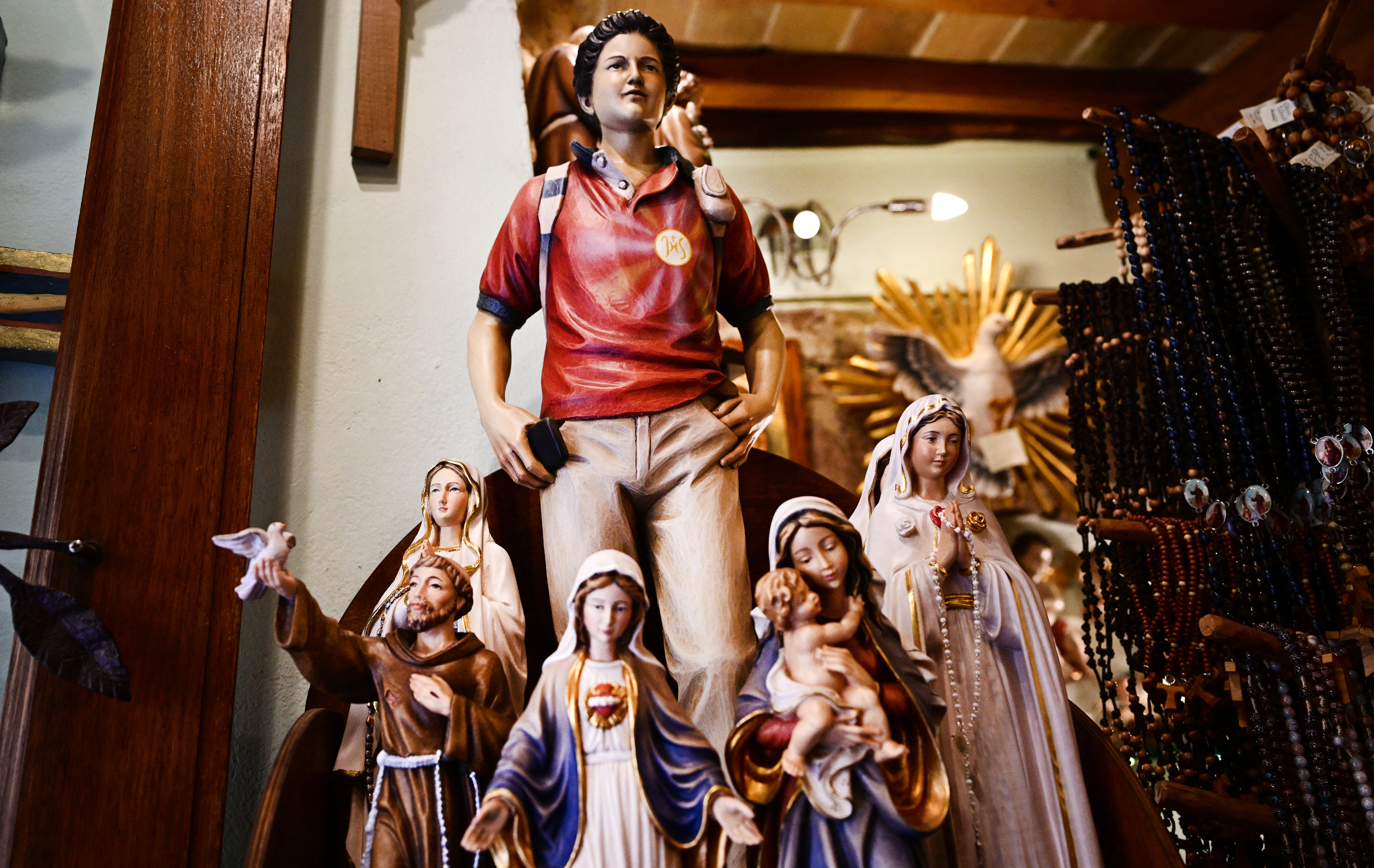 Figurines of Blessed Carlo Acutis,  an adolescent who spent his life spreading his faith online, earning the moniker "God's Influencer", are on sale in a souvenirs shop in Assisi where Acutis is on display, on April 3, 2025.
