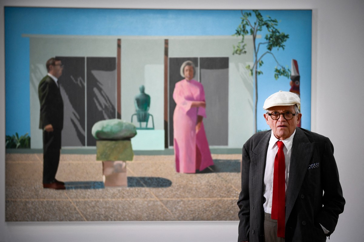 (FILES) British artist David Hockney poses in front of his painting "Fred and Marcia Weisman" during a photo session at the Pompidou Centre in Paris, on June 16, 2017.