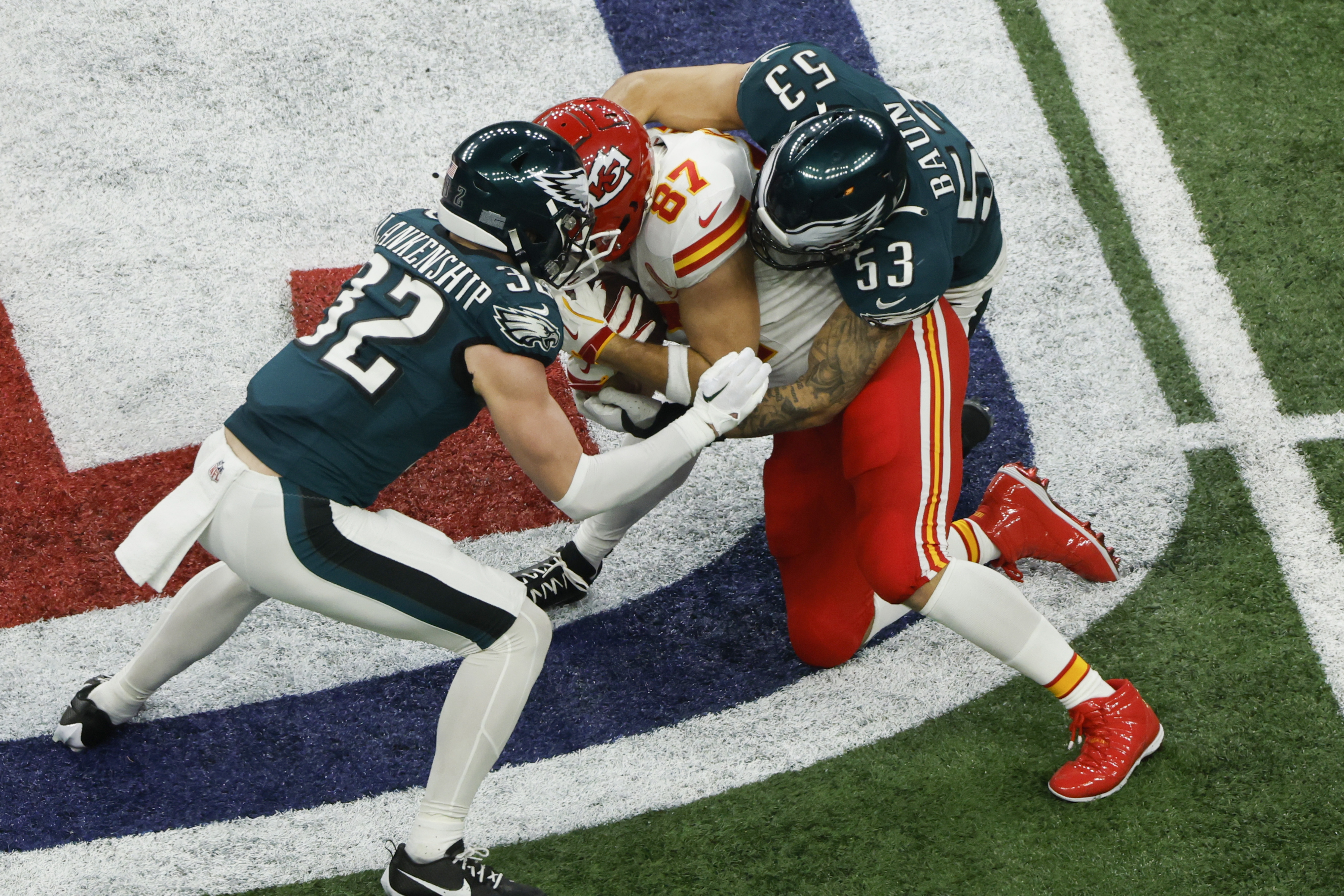 -FOTODELDIA- NUEVA ORLEANS (ESTADOS UNIDOS), 10/02/2025.- El ala cerrada de los Kansas City Chiefs Travis Kelce (c) es placado por Reed Blankenship (i) y Zack Baun (d) de los Philadelphia Eagles durante la Super Bowl disputada en el estadio Caesars Superdome de Nueva Orleans, Louisiana, Estados Unidos. EFE/CJ Gunther