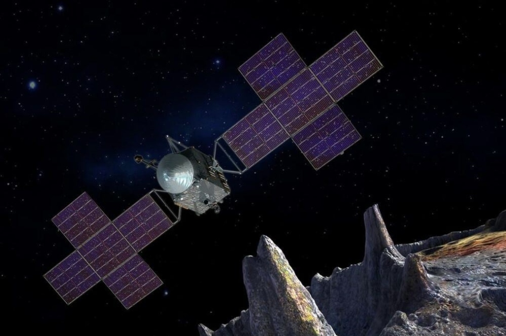 Esta ilustración representa a la nave espacial de la misión Psyche, de la NASA, cerca del objetivo de la misión, el asteroide metálico que lleva el mismo nombre.