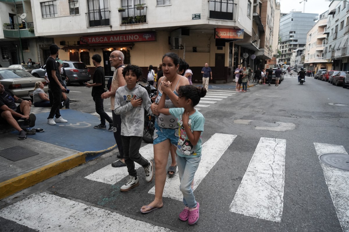 People remain on a street following an earthquake in Caracas on June 24, 2026.