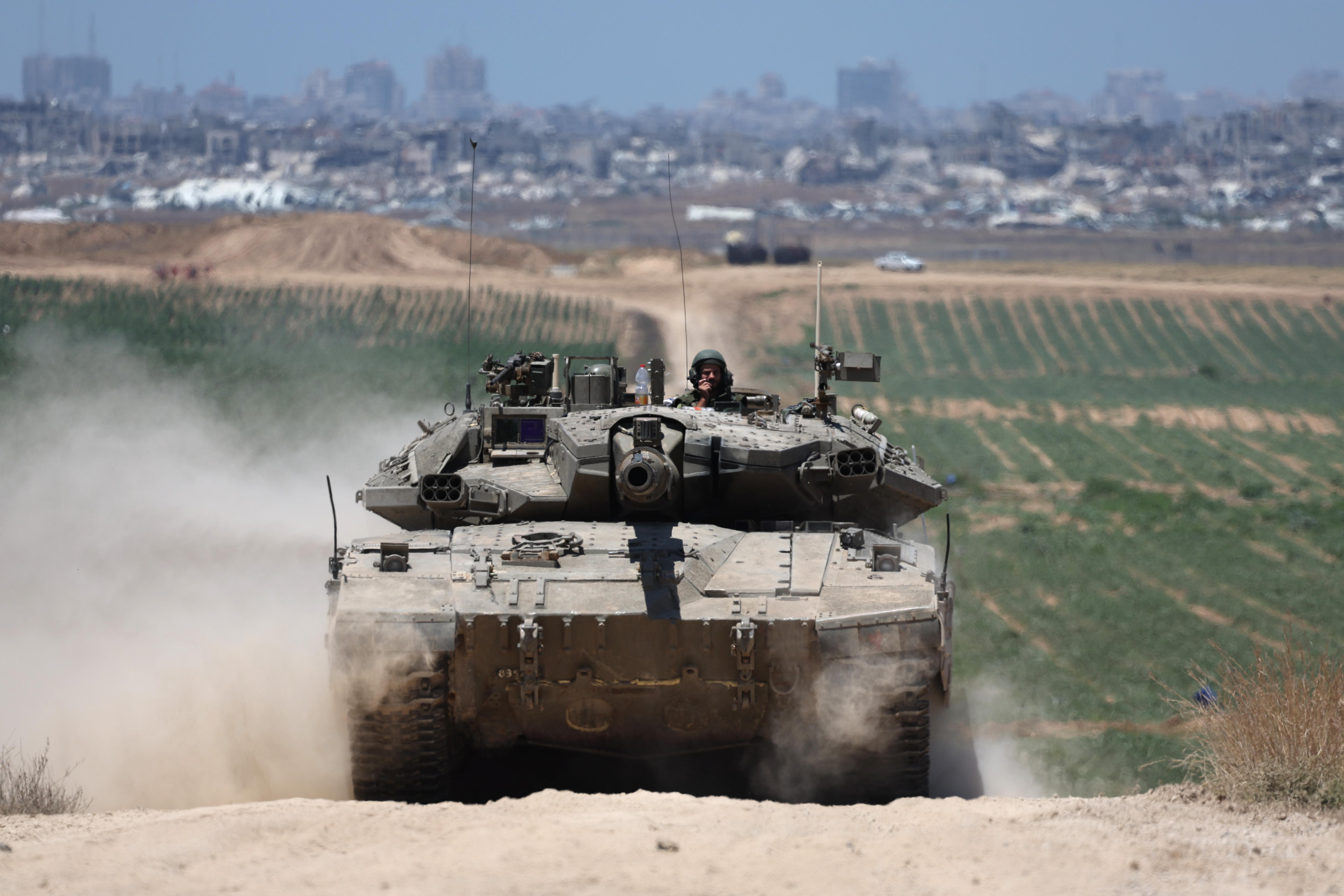 Southern Israel (Israel), 16/05/2024.- Israeli tanks patroll near the security fence with Jabalia in the northern part of the Gaza Strip, in the background, southern Israel, 16 May 2024. More than 35,100 Palestinians and over 1,455 Israelis have been killed, according to the Palestinian Health Ministry and the Israel Defense Forces (IDF), since Hamas militants launched an attack against Israel from the Gaza Strip on 07 October 2023, and the Israeli operations in Gaza and the West Bank which followed it. EFE/EPA/ATEF SAFADI