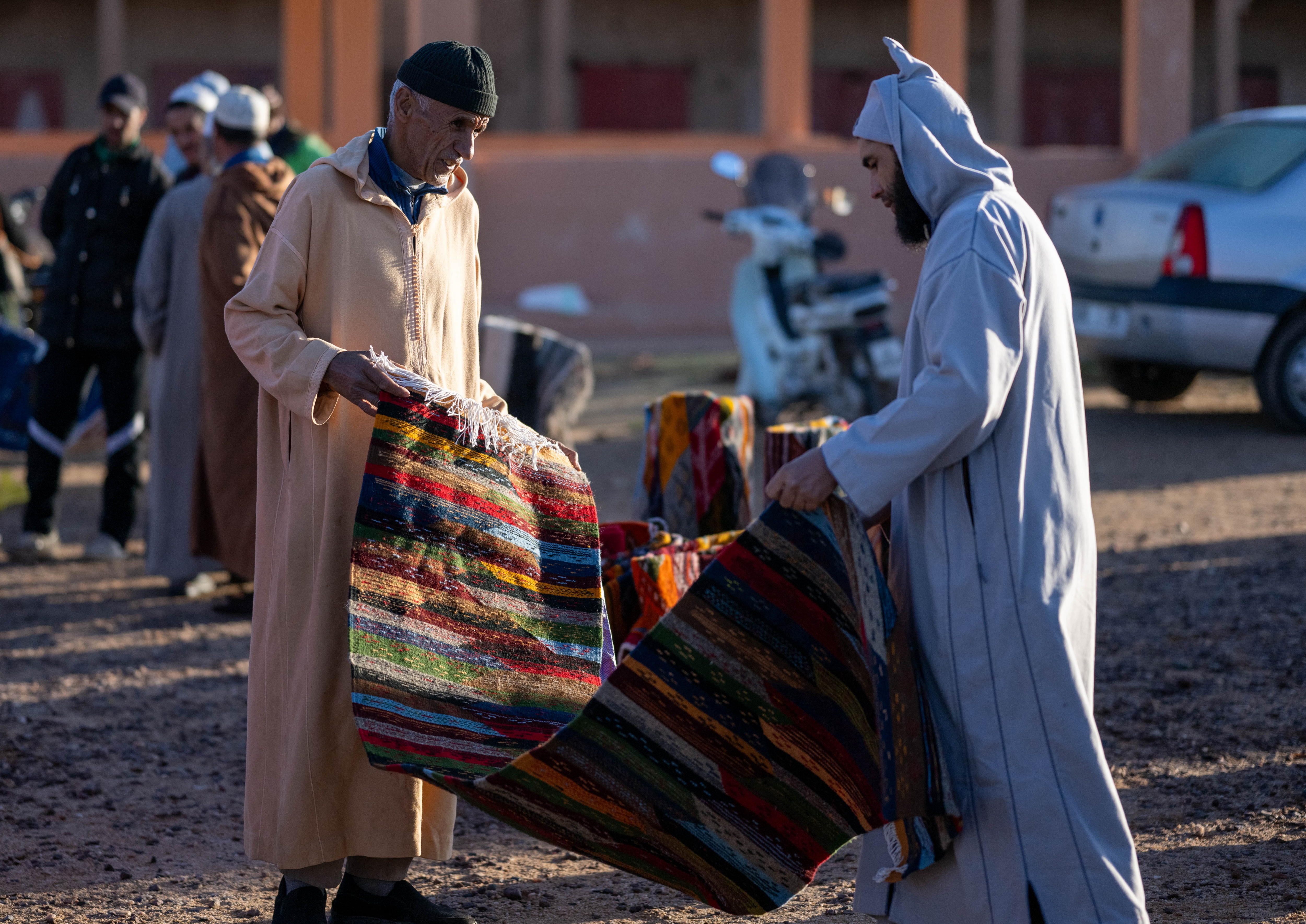 Taznakht (Morocco), 21/11/2024.- A carpet seller talks to customers at the weekly market in Taznakht, Ouarzazate province, Moroccoa, 21 November 2024, during the seventh edition of the Ait Ouaouzguit Carpet Festival running from 20 to 24 November under the theme 'The Ait Ouaouzguit Carpet: Between Tourism Valorization and Socio-Economic Empowerment of Women Weavers.' The region in south-eastern Morocco is famous for producing Ouzguit carpets, named after the Ait Ouzguit tribes, which are Berber tribes that inhabited the southern slopes of the High Atlas Mountains. (Marruecos) EFE/EPA/JALAL MORCHIDI