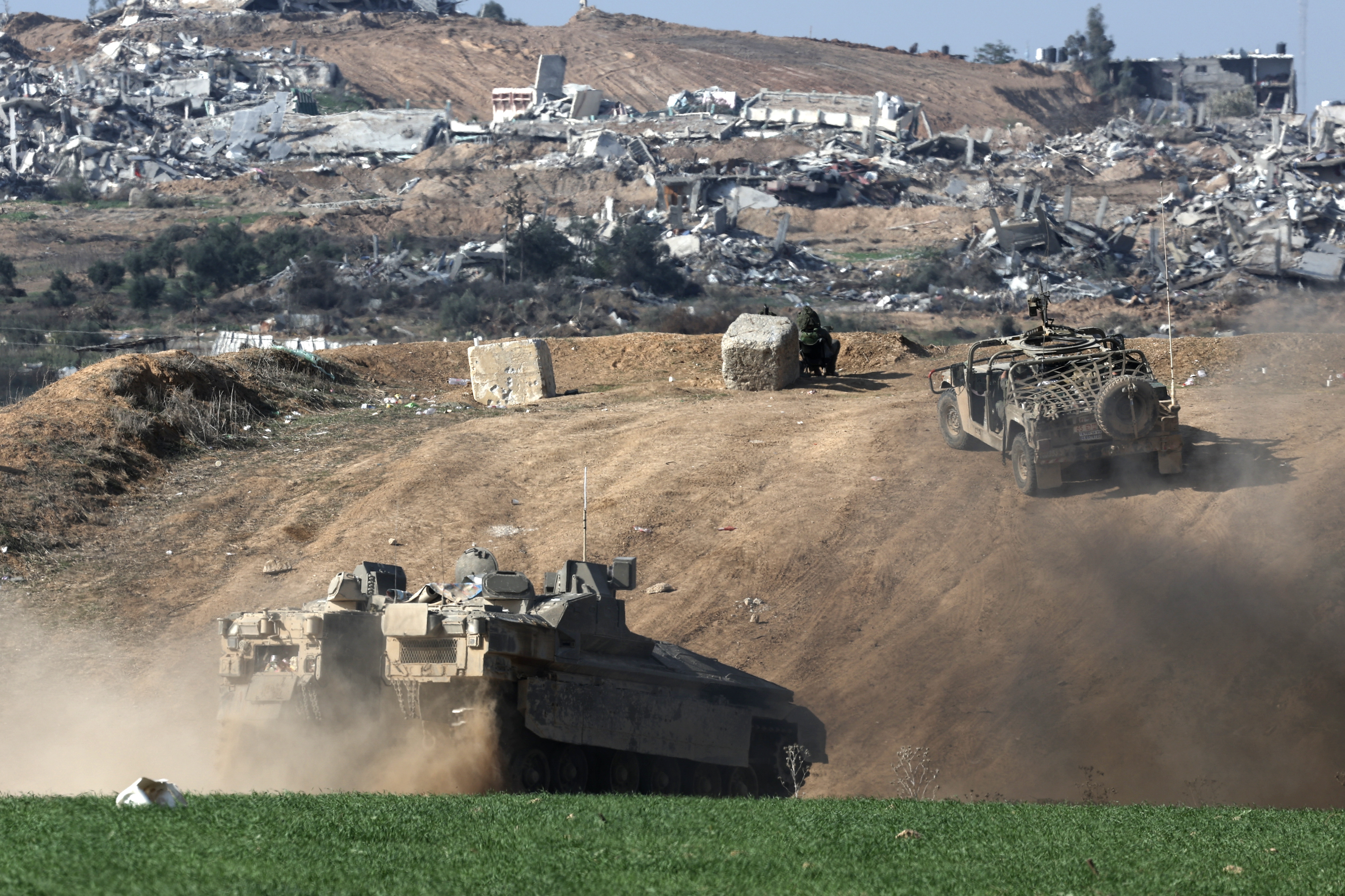 Undisclosed Location (Israel), 29/12/2023.- An Israeli armoured personnel carrier (APC) patrols next to a position near Israeli-Gaza border, overlooking the Shujaiya neighborhood in the Gaza Strip, in southern Israel, 29 December 2023. More than 20,900 Palestinians and at least 1,300 Israelis have been killed, according to the Palestinian Health Ministry and the Israel Defense Forces (IDF), since Hamas militants launched an attack against Israel from the Gaza Strip on 07 October, and the Israeli operations in Gaza and the West Bank which followed it. The Israeli military stated that its ground, air, and naval troops are 'continuing to strike' targets in the Gaza Strip. EFE/EPA/ATEF SAFADI EPA-EFE/ATEF SAFADI