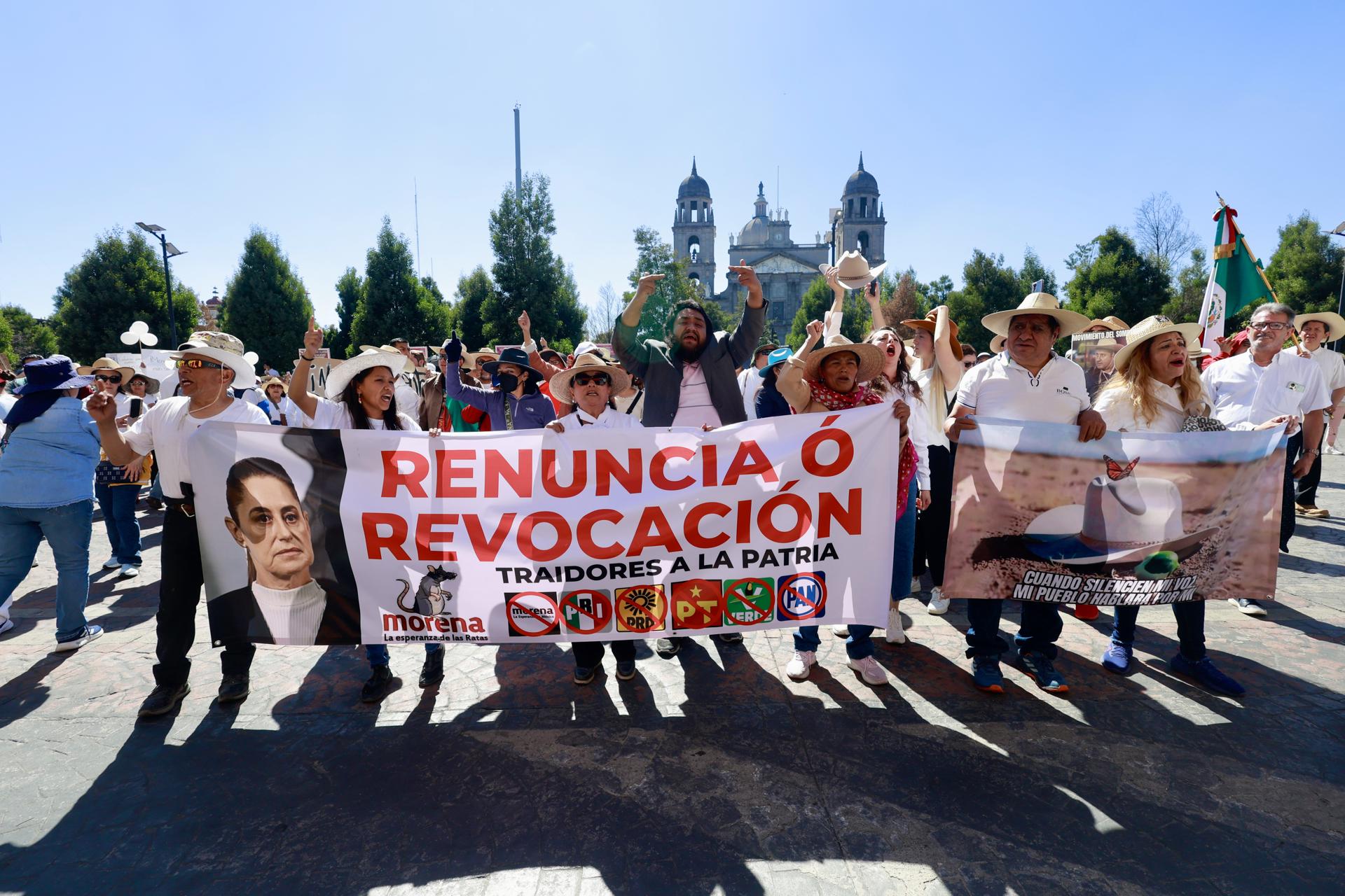 People holding a sign in a protest in the city of Toluca, Mexico, 15 November 2025. Waving flags and chanting “Claudia (Sheinbaum) must go!”, hundreds of Mexicans protested to express their “political weariness” with the government led by the Mexican president and denounce the “impunity” in the face of the violence plaguing the country. EFE/ Felipe Gutierrez