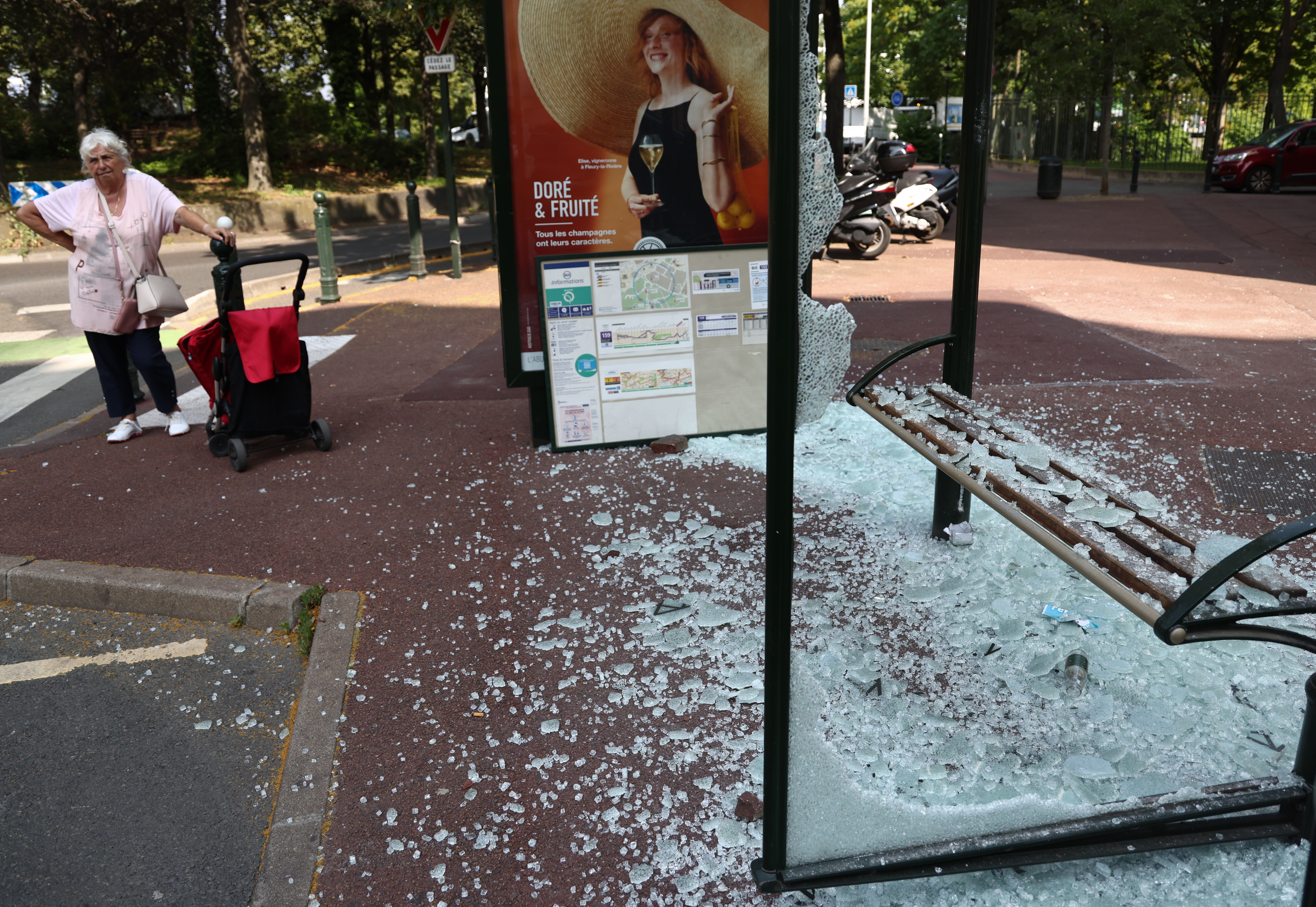 Nanterre (France), 28/06/2023.- A man stands next to a destroyed bus- top on avenue Pablo Picasso following a night of civil unrest, in Nanterre, near Paris, France, 28 June 2023. The violence broke out after police fatally shot a 17-year-old during a traffic stop in Nanterre. According to the French interior minister, 31 people were arrested with 2,000 officers being deployed to prevent further violence. (Disturbios, Francia) EFE/EPA/Mohammed Badra