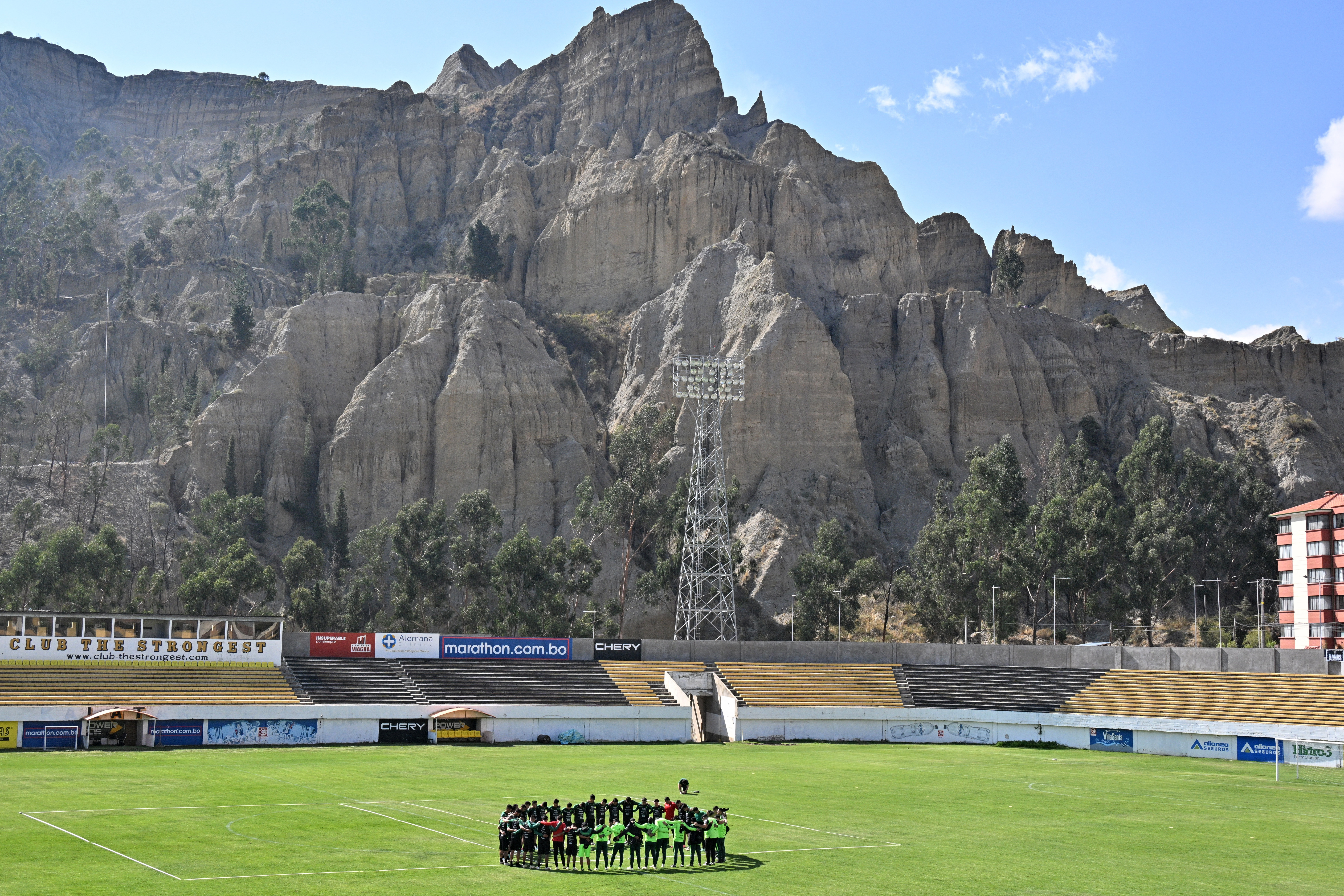 Bolivia's national team football players gather in a huddle during a training session at the Rafael Mendoza Stadium in La Paz on October 6, 2024.