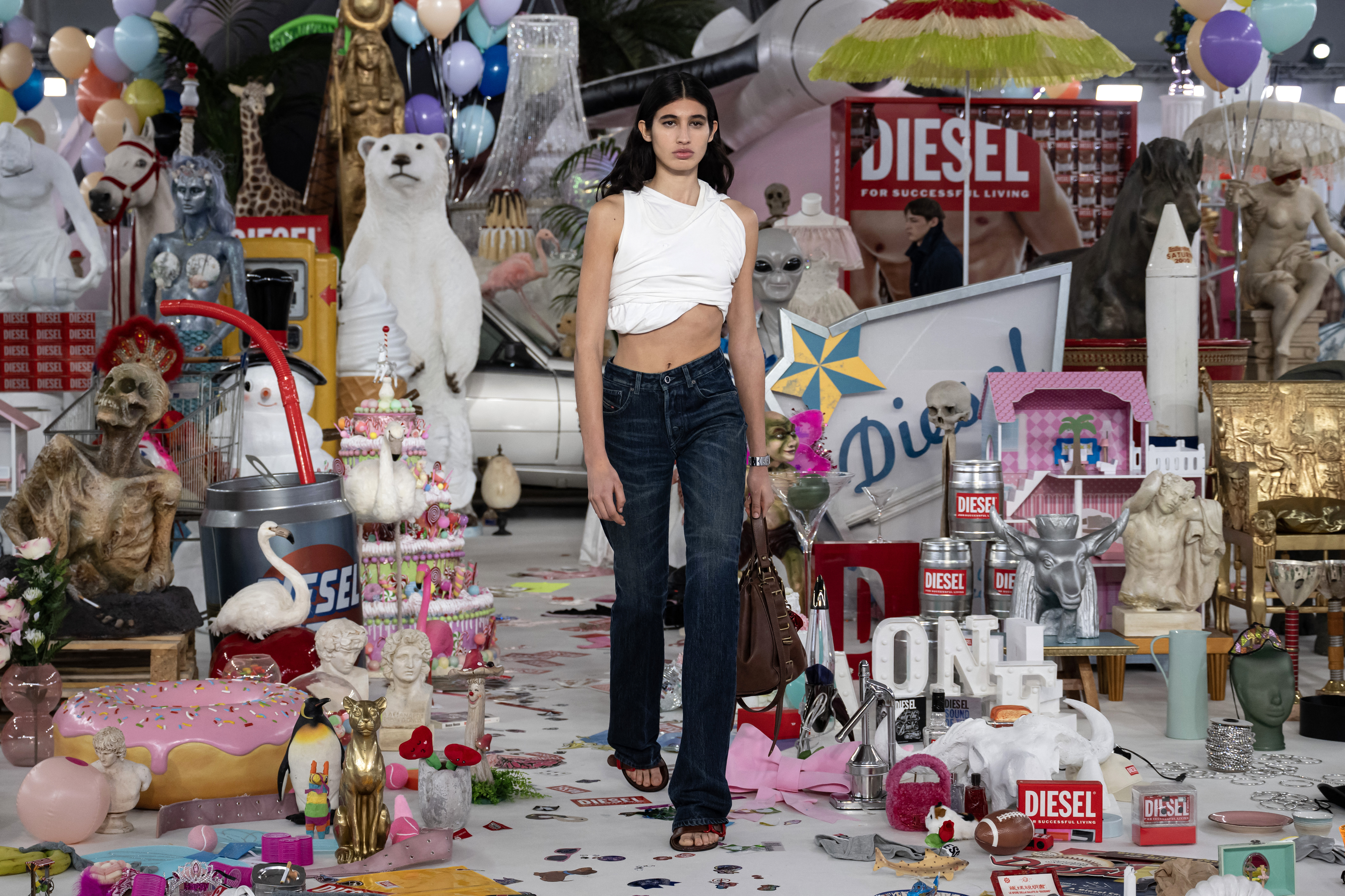 El denim se trata con resina para crear pliegues permanentes, como si los jeans se hubieran usado toda la noche y todo el día, una y otra vez. Algunos jeans son extra largos, con aberturas verticales ocultas cerca del tobillo, perfectas para deslizar un tacón de aguja. Se cierran con broches de gancho y ojal para un giro adicional.  / Miguel Medina / AFP