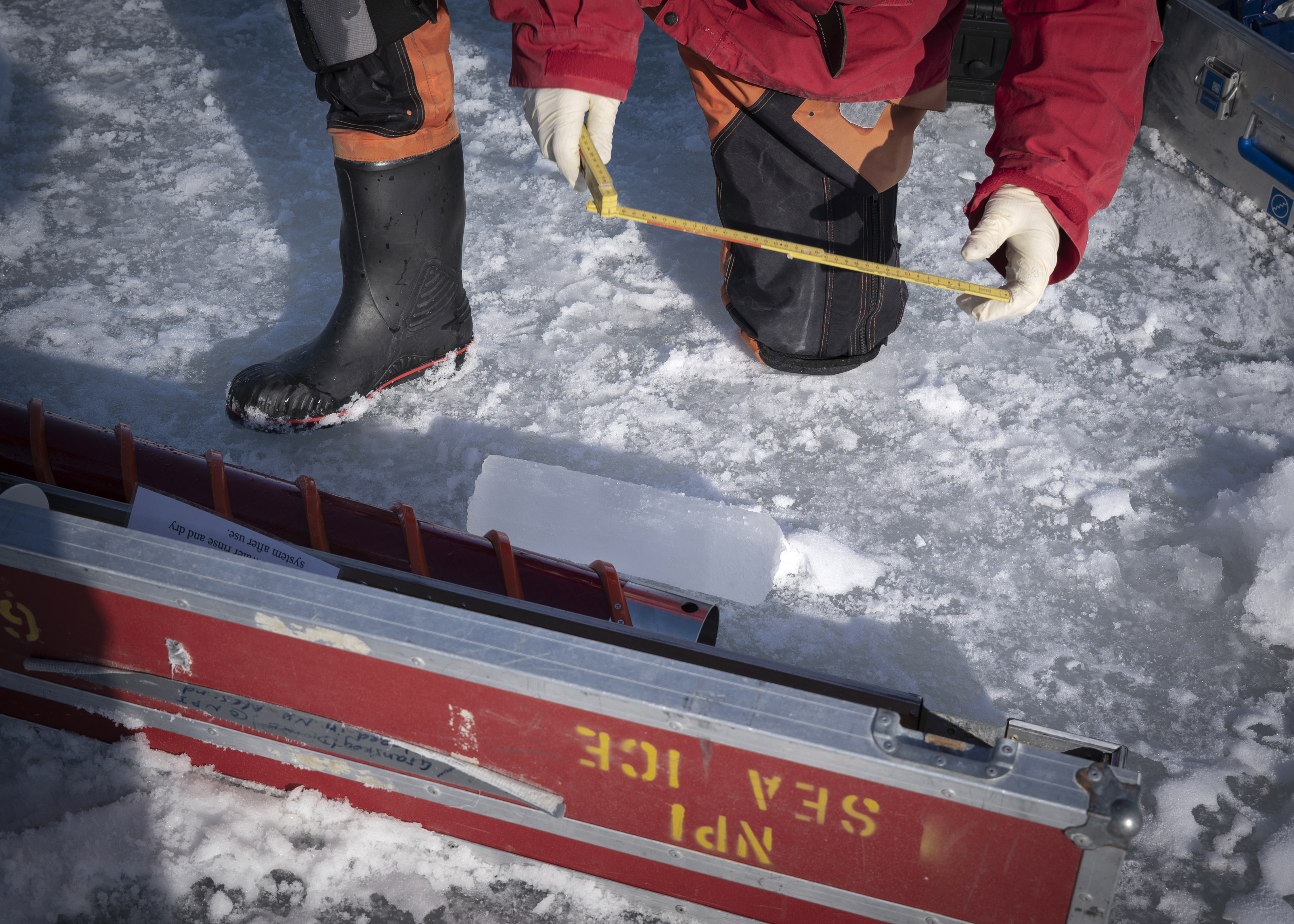Dmitry Divine, un científico del Norwegian Polar Institute, mide un pedazo de hielo del mar en archipiélago noruego de Svalbard.