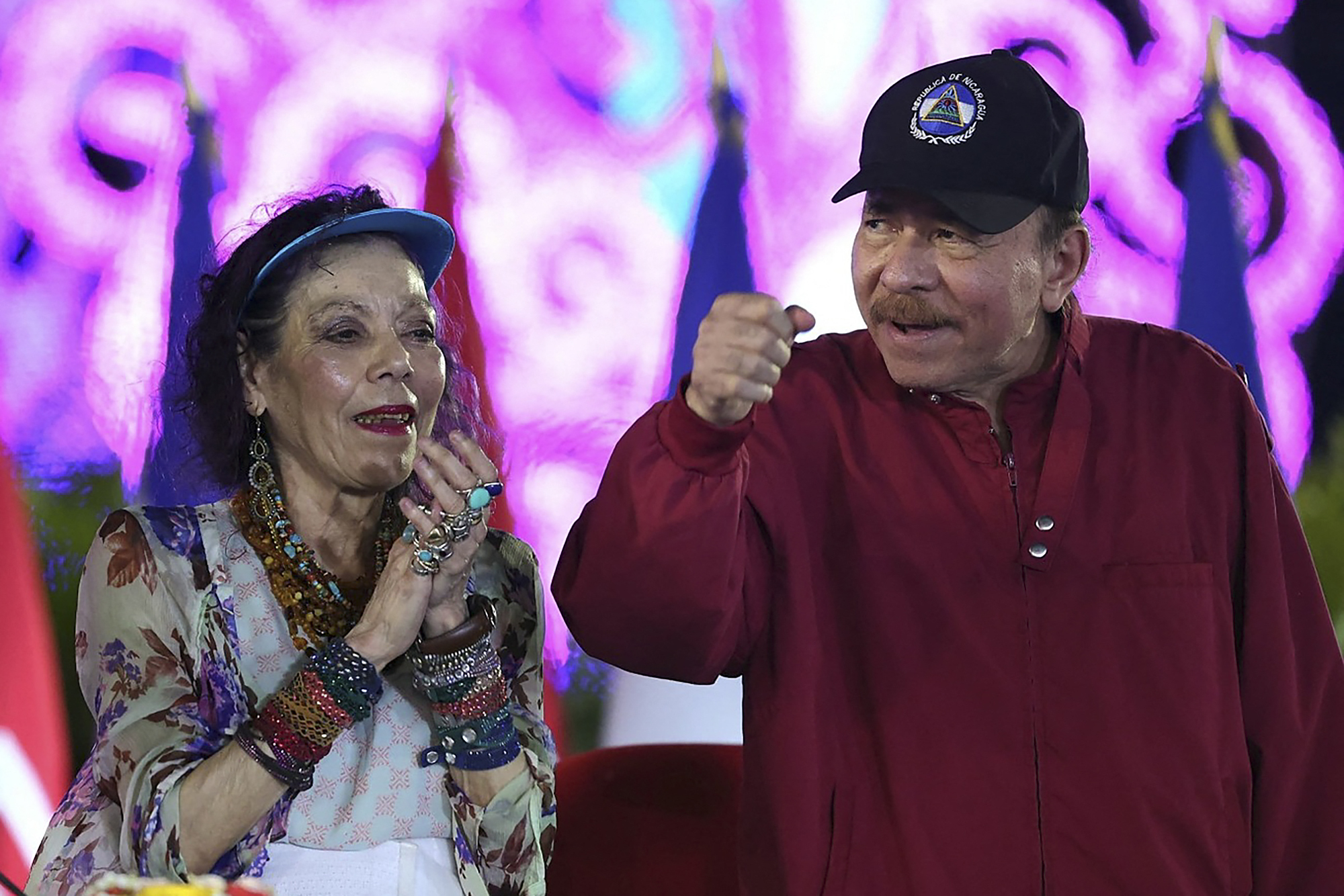 This handout picture released by the official El 19 Digital news outlet shows Nicaraguan President Daniel Ortega and Co-President Rosario Murillo gesturing during Labor Day celebrations in Managua on 30 April, 2025.