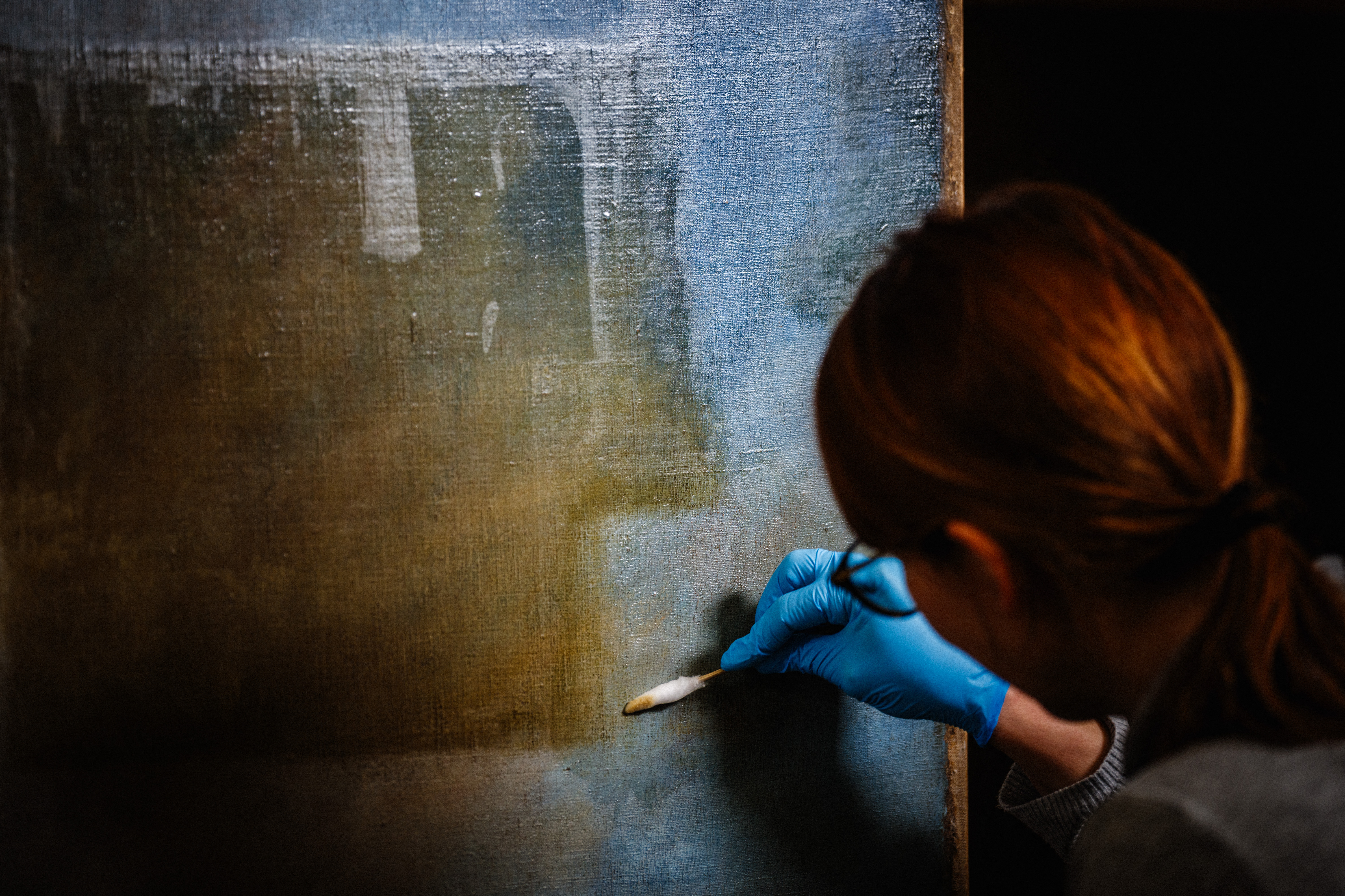 A restoration artist works on the restoration of the painting "Liberty Leading the People" (1830) by French artist Eugene Delacroix (1798-1863), at a laboratory inside the Louvre Museum in Paris, on February 28, 2024.