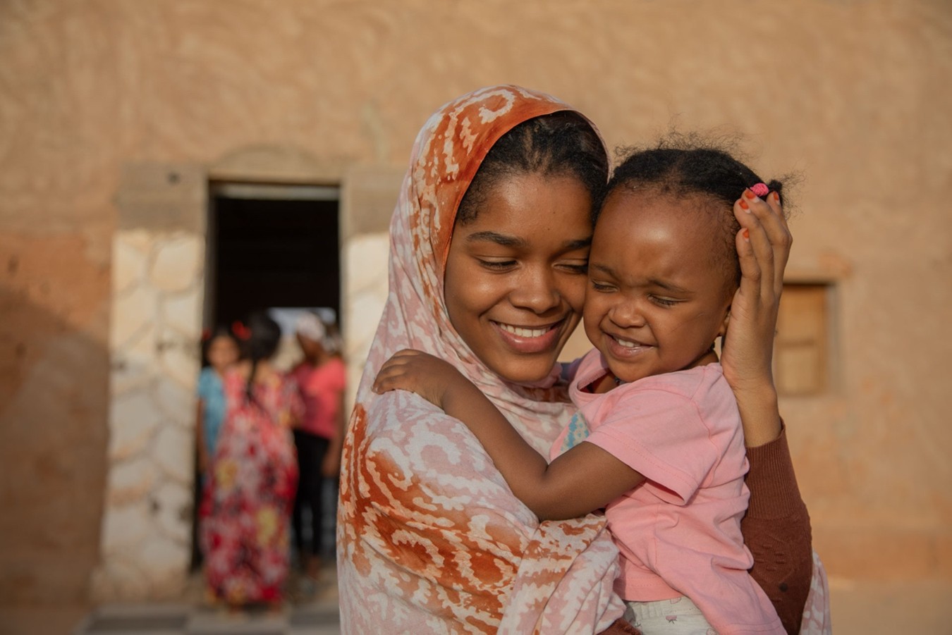 Maima juega con su prima Leila. La familia es considerada la unidad fundamental de la sociedad islámica. Campamentos de refugiados saharauis, Tinduf, Argelia.