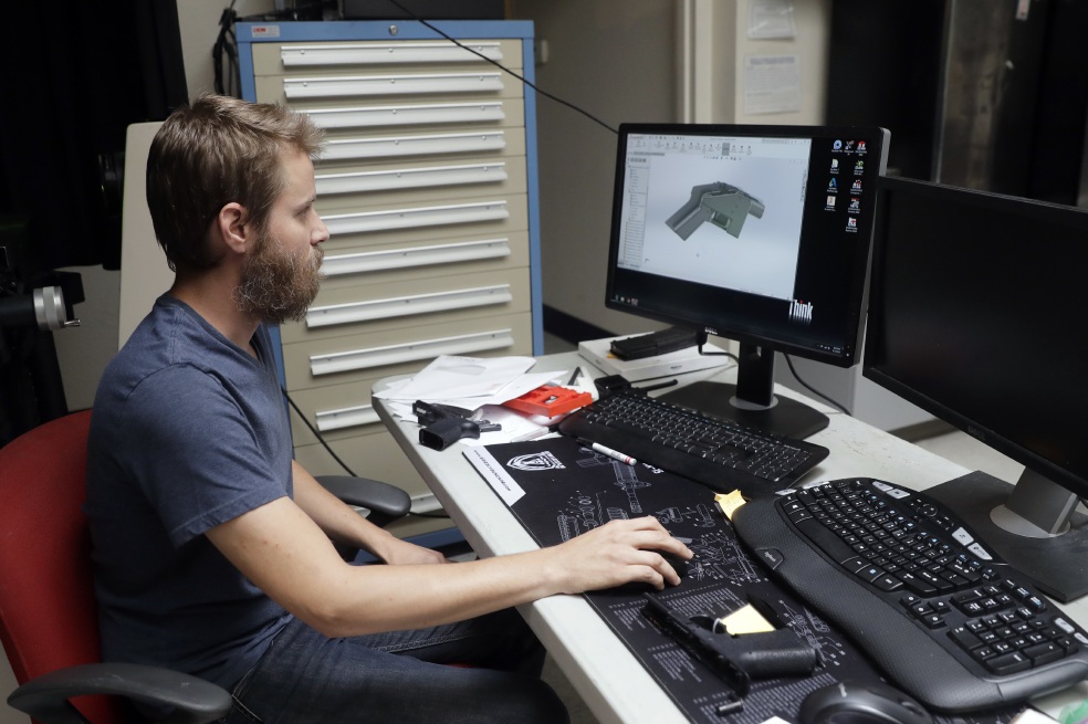 Ben Chalker shows the CAD software of a 3D-printable gun called the Liberator, Wednesday, Aug. 1, 2018, in Austin, Texas. A federal judge in Seattle  issued a temporary restraining order Tuesday to stop the release of blueprints to make untraceable and undetectable 3D-printed plastic guns. (AP Photo/Eric Gay)