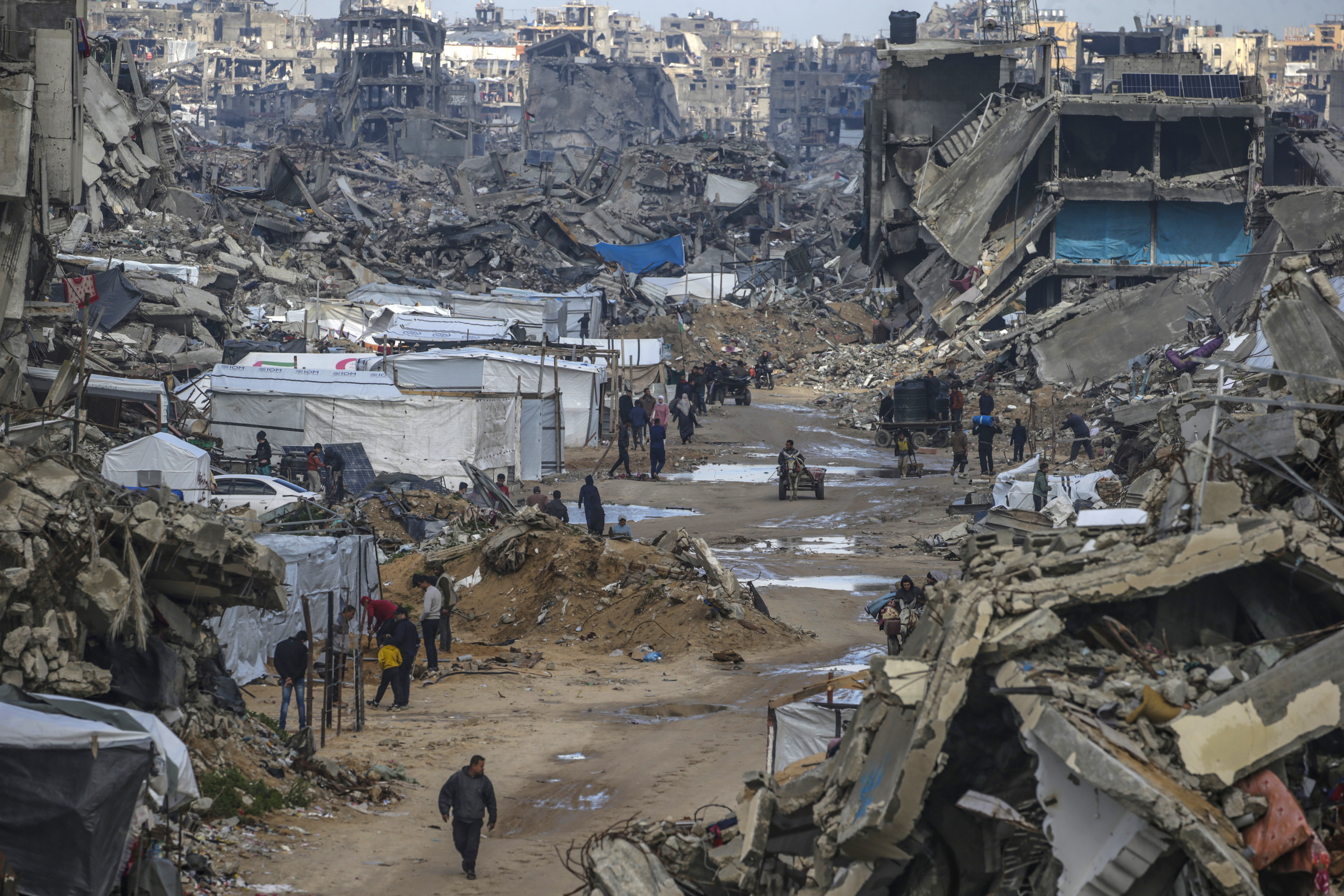 Jabalya (-), 13/02/2025.- Palestinians walk along a road next to the rubble of destroyed buildings amid a ceasefire between Israel and Hamas, in Jabalya, northern Gaza Strip, 13 February 2025. Israel and Hamas implemented the first phase of a hostage release and ceasefire deal on 19 January 2025. More than 46,000 Palestinians have been killed in the Gaza Strip, according to the Palestinian Ministry of Health, since Israel launched a military campaign in the strip in response to a cross-border attack led by the Palestinian militant group Hamas on 07 October 2023, in which about 1,200 Israelis were killed and more than 250 taken hostage. EFE/EPA/MOHAMMED SABER