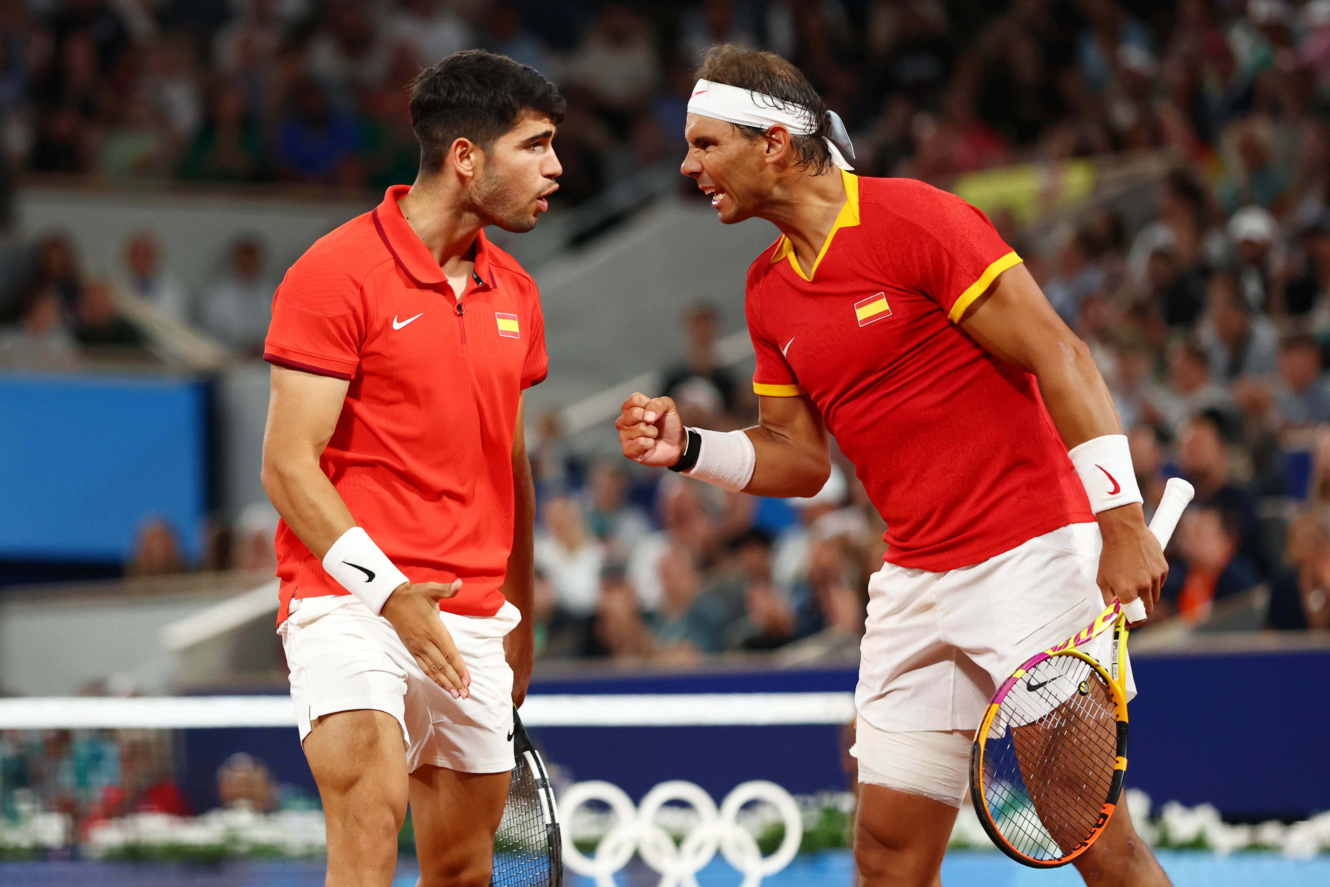 Paris (France), 27/07/2024.- Rafael Nadal (R) and Carlos Alcaraz of Spain react during their Men's Doubles first round match against Maximo Gonzalez and Andres Molteni of Argentina at the Tennis competitions in the Paris 2024 Olympic Games, at the Roland Garros in Paris, France, 27 July 2024. (Tenis, Francia, España) EFE/EPA/DIVYAKANT SOLANKI