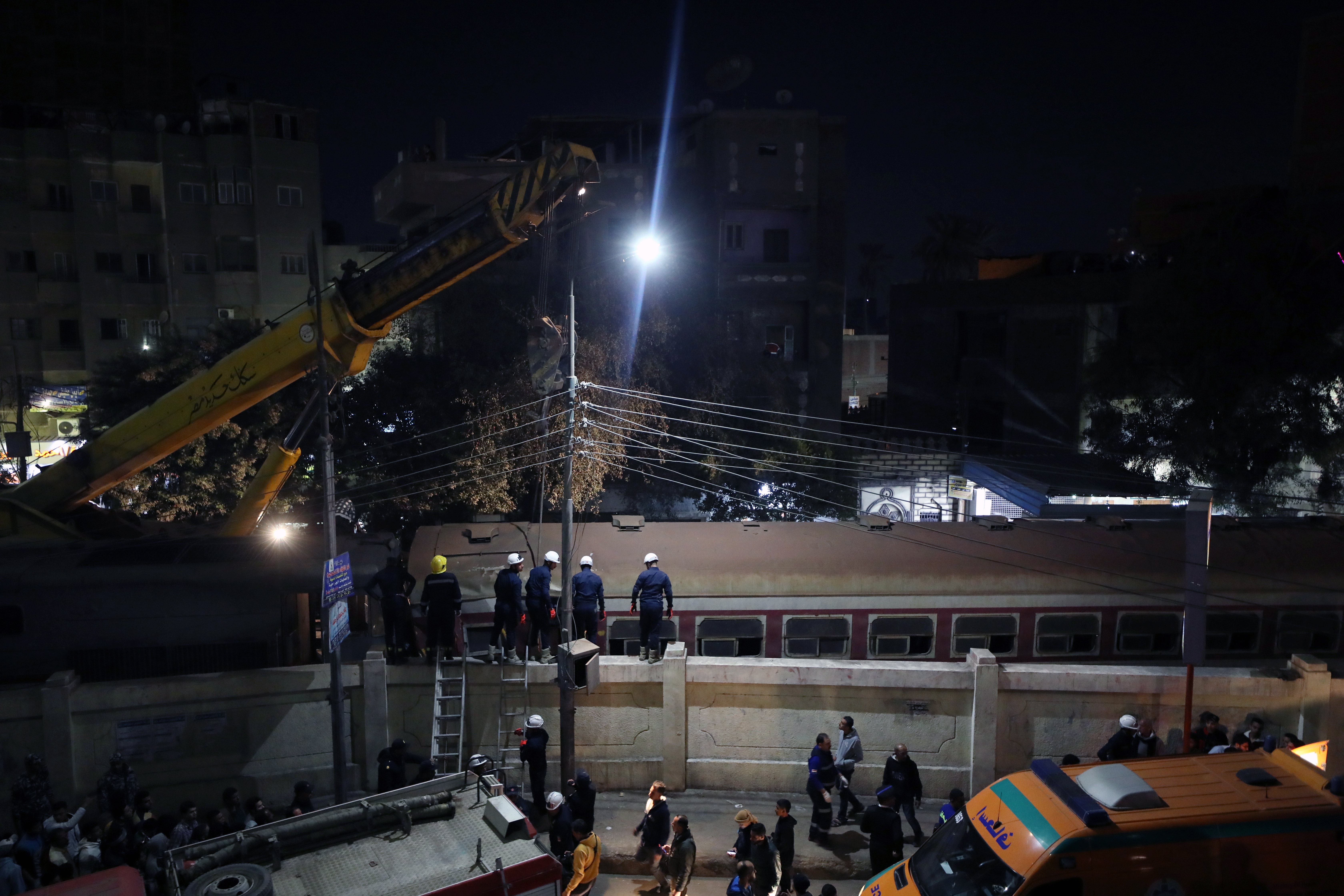 Al Qalyubia (Egypt), 07/03/2023.- A crane lifts a damaged carriage of a passenger train that was derailed in Toukh, Al Qalyubia Governorate, north of Cairo, Egypt, 07 March 2023. According to initial reports by the Egyptian Ministry of Health and Population, two people were killed in the accident that occurred on the evening of 07 March. (Egipto) EFE/EPA/KHALED ELFIQI