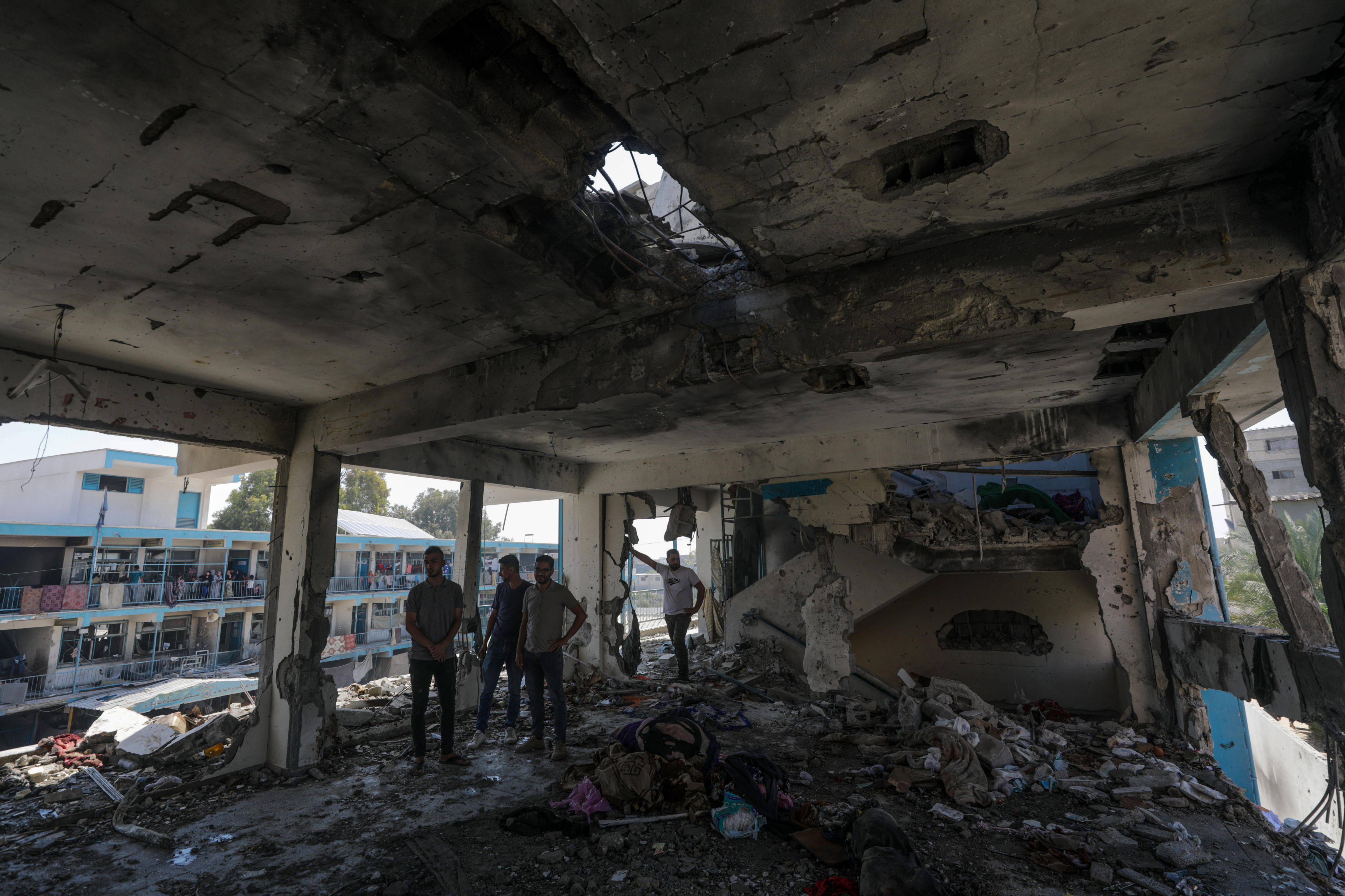 Al Nusairat Refugee Camp (-), 06/06/2024.- Palestinians inspect a destroyed UNRWA school following Israeli airstrike at Al Nusairat refugee camp in the central Gaza Strip, 06 June 2024. According to the Palestinian News Agency Wafa, at least 32 people were killed and dozens others were injured on early 06 June following an Israeli strike on a UNRWA school sheltering displaced Palestinians, located in the Nuseirat refugee camp in the central Gaza strip. The Israeli army said that it had "conducted a precise strike on a Hamas compound", whose members were " embedded in the UNRWA school". More than 36,000 Palestinians and over 1,400 Israelis have been killed, according to the Palestinian Health Ministry and the Israel Defense Forces (IDF), since Hamas militants launched an attack against Israel from the Gaza Strip on 07 October 2023, and the Israeli operations in Gaza and the West Bank which followed it. EFE/EPA/MOHAMMED SABER