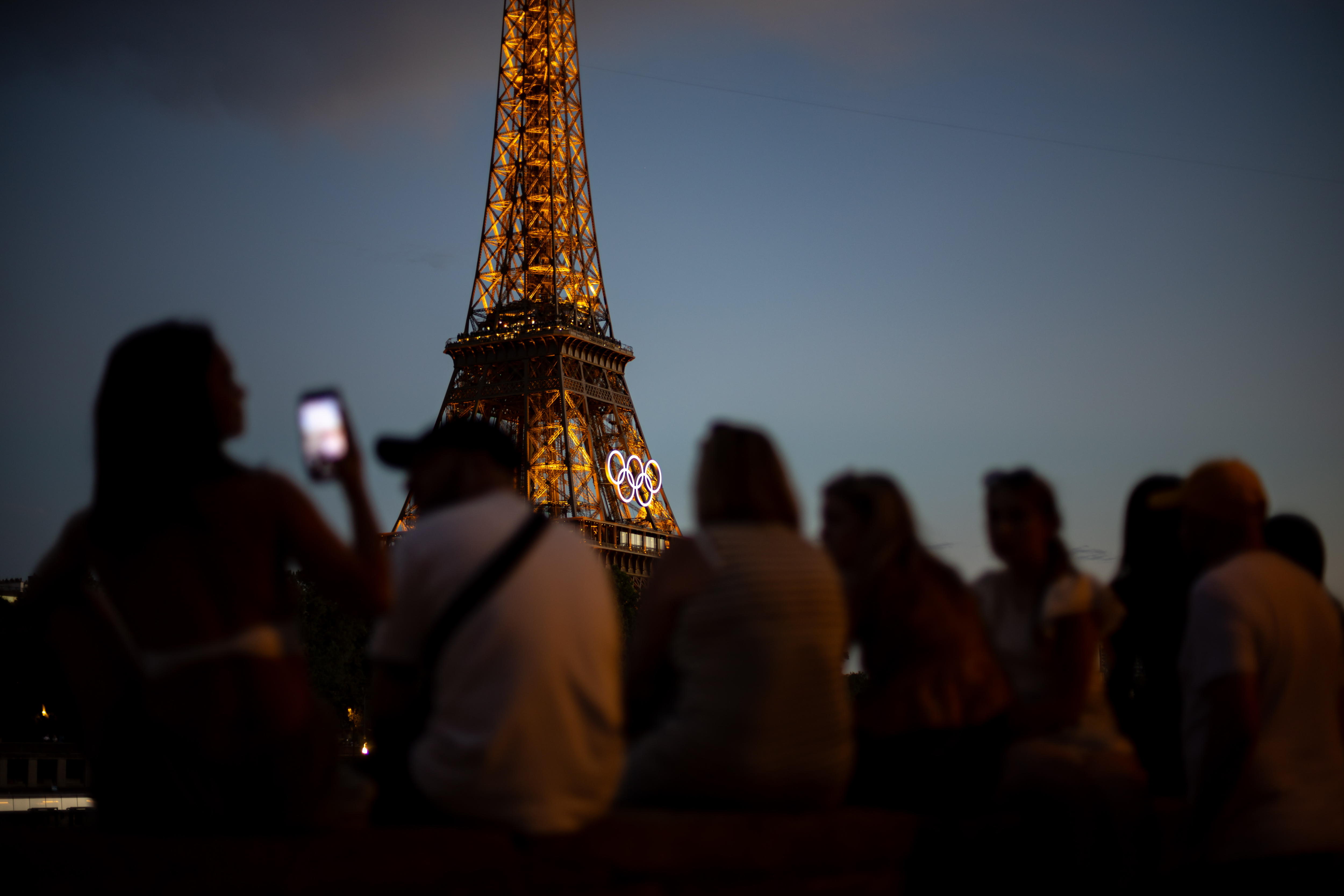 Paris (France), 11/08/2024.- People enjoy sunset near the Eiffel Tower while the Closing Ceremony of the Paris 2024 Olympic Games is taking place at the Stade de France, Paris, France, 11 August 2024. (Francia) EFE/EPA/MARTIN DIVISEK