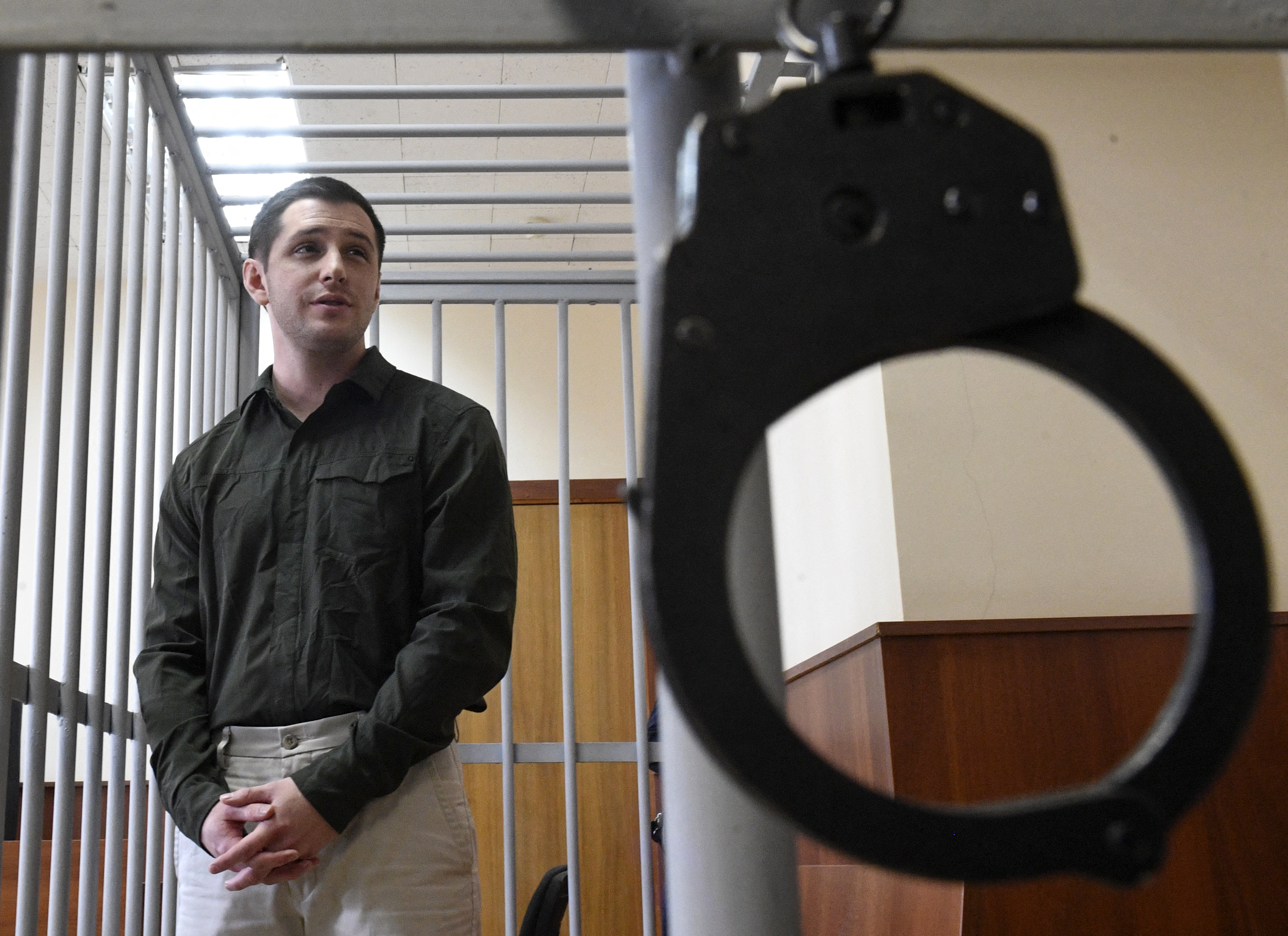 El exmarine estadounidense Trevor Reed, acusado de atacar a la policía, se encuentra dentro de una jaula de acusados durante una audiencia judicial en Moscú el 11 de marzo de 2020.